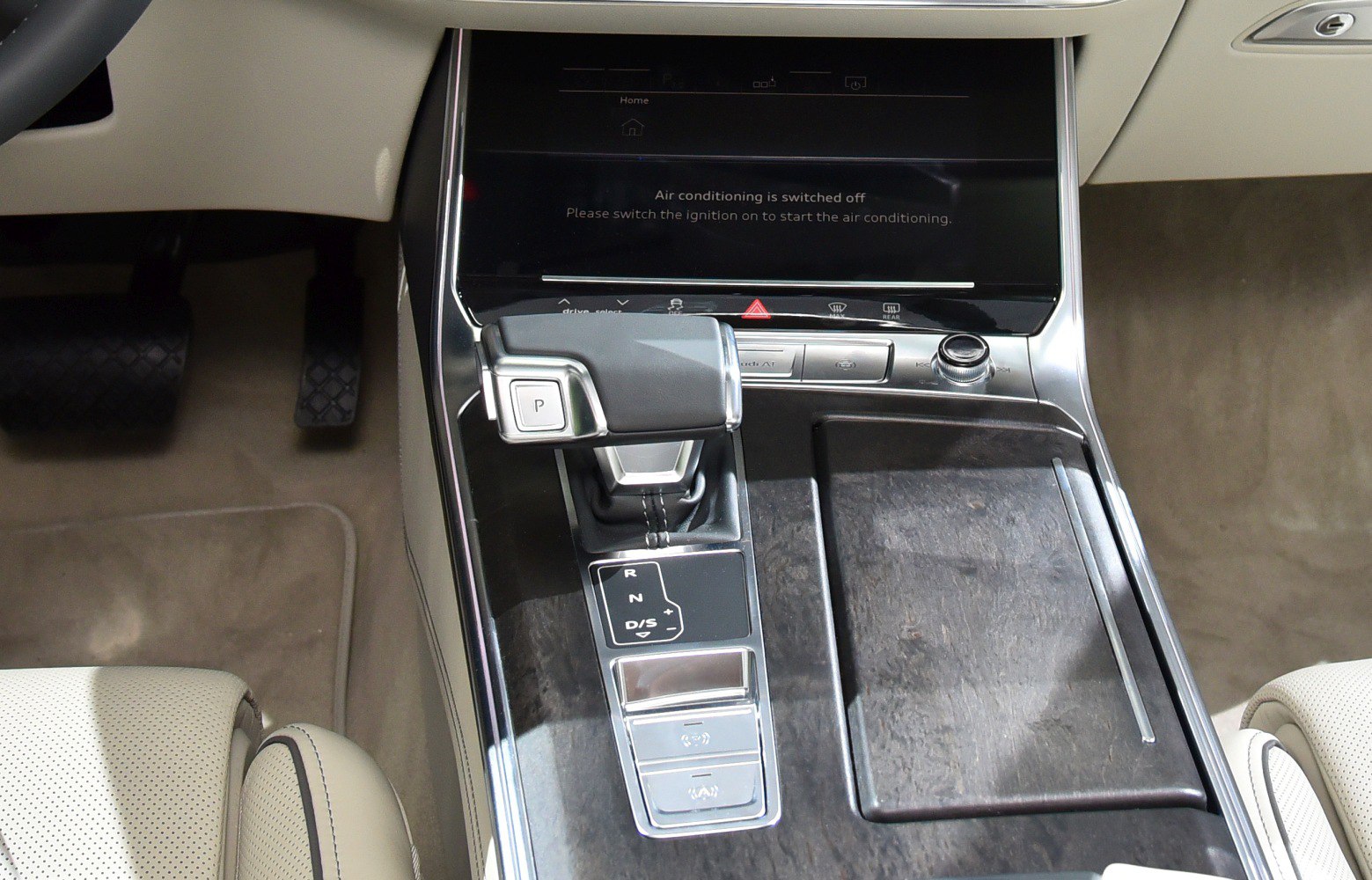 Gear shift lever and center console with controls in luxury sedan interior