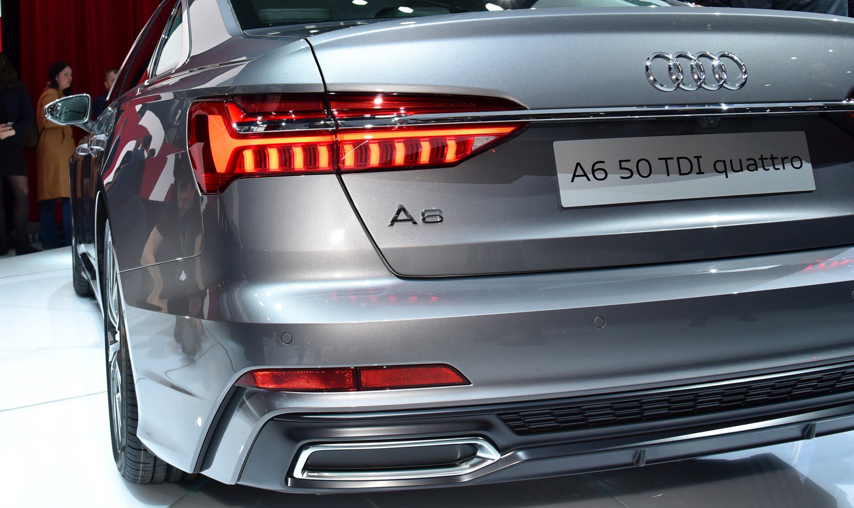 LED rear tail light and chrome exhaust of a modern luxury sedan