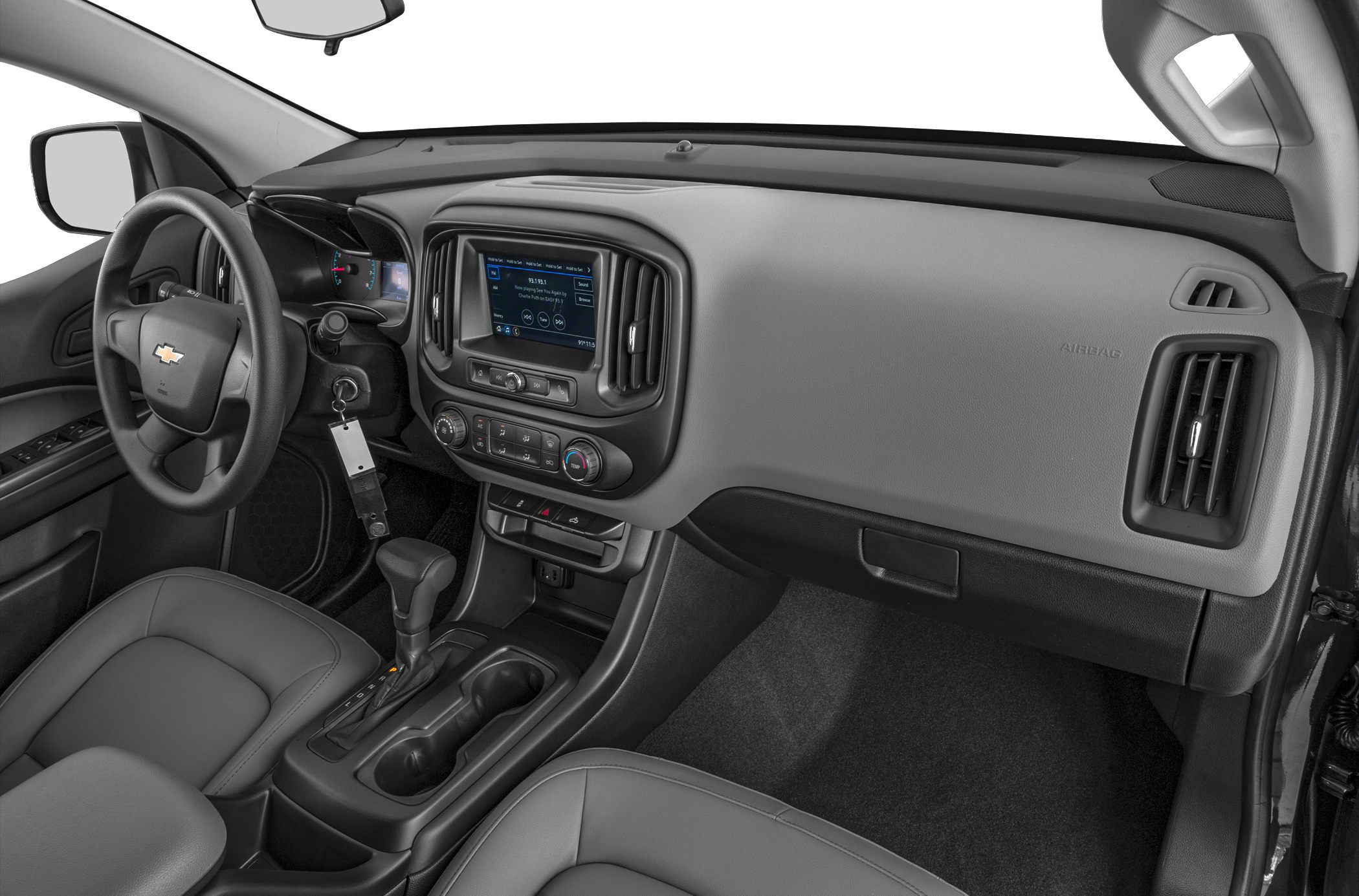Car interior with dashboard, steering wheel, touchscreen, and gear shifter