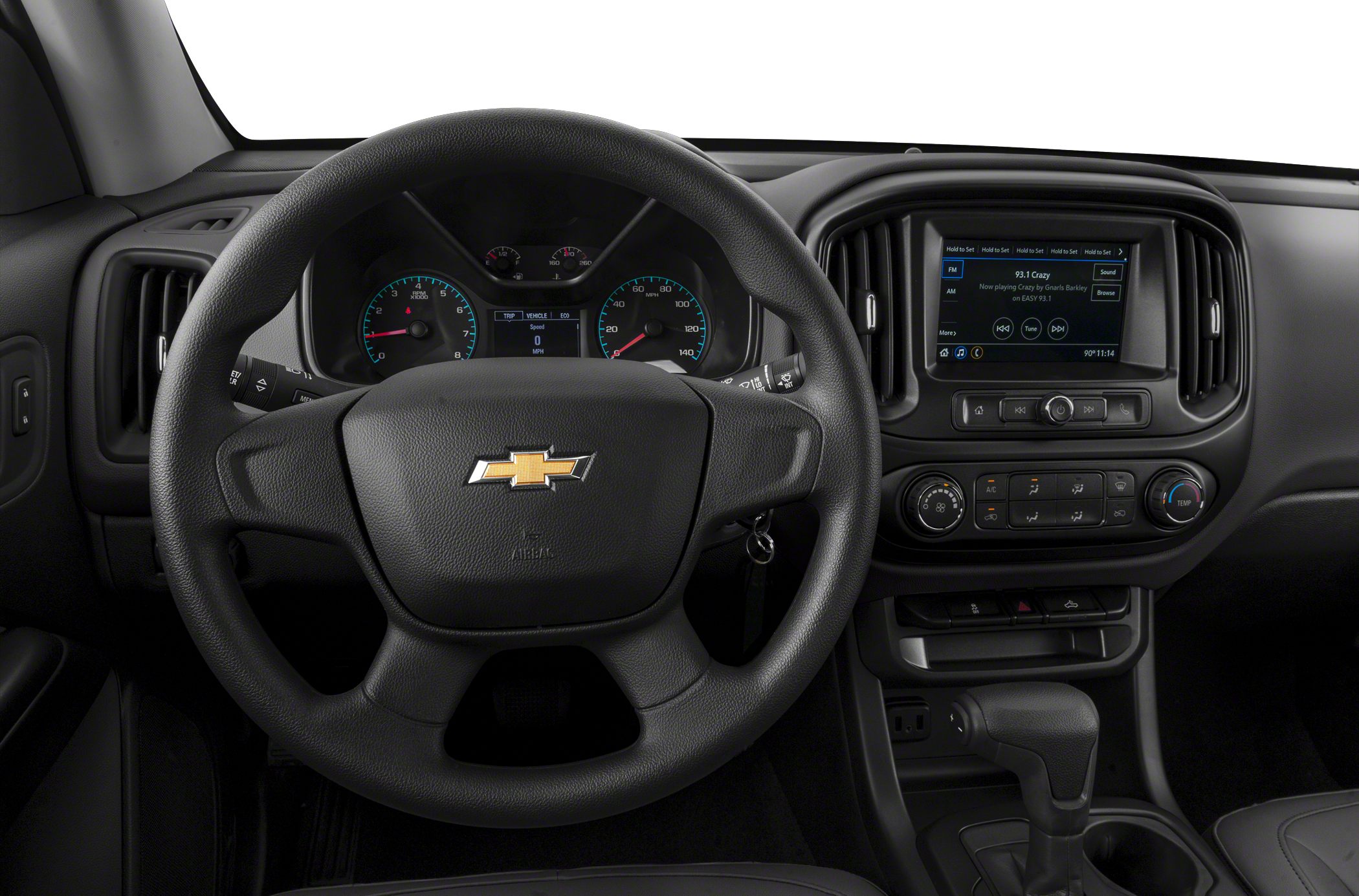 Steering wheel, instrument cluster, and infotainment display in a vehicle interior