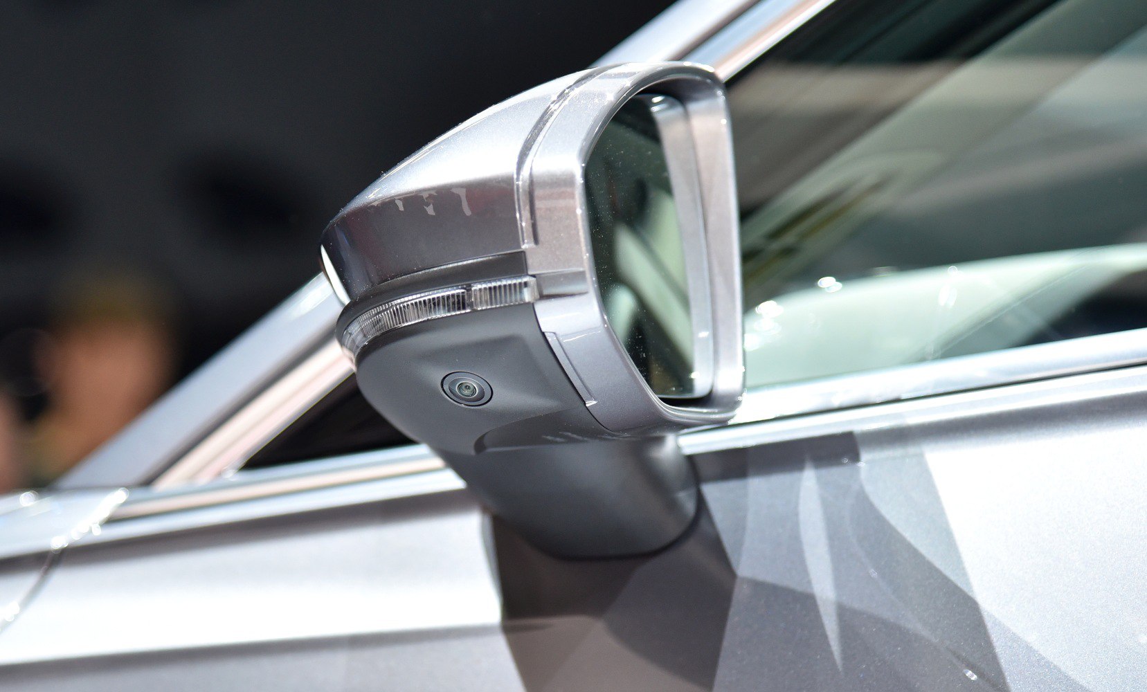 Close-up of side mirror with integrated camera and turn signal