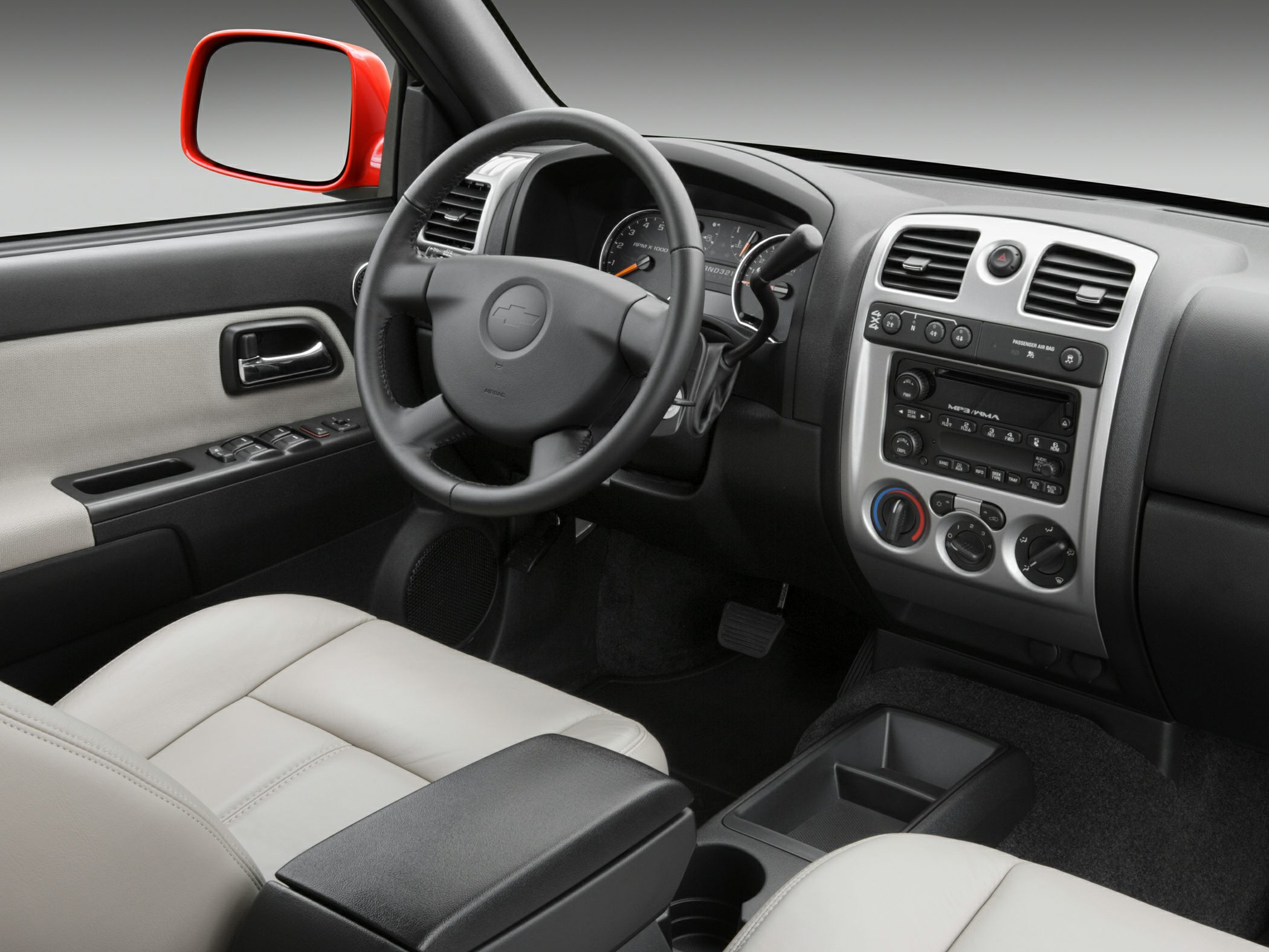 Dashboard, steering wheel, controls, light-colored seats interior