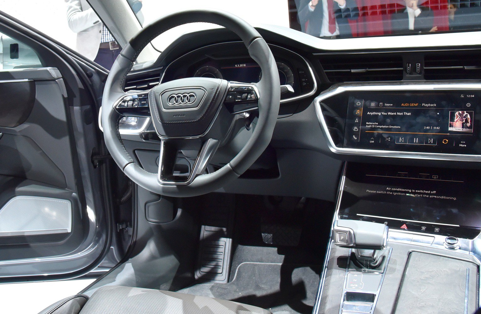 Luxury steering wheel and dual touchscreen infotainment display in a modern car interior