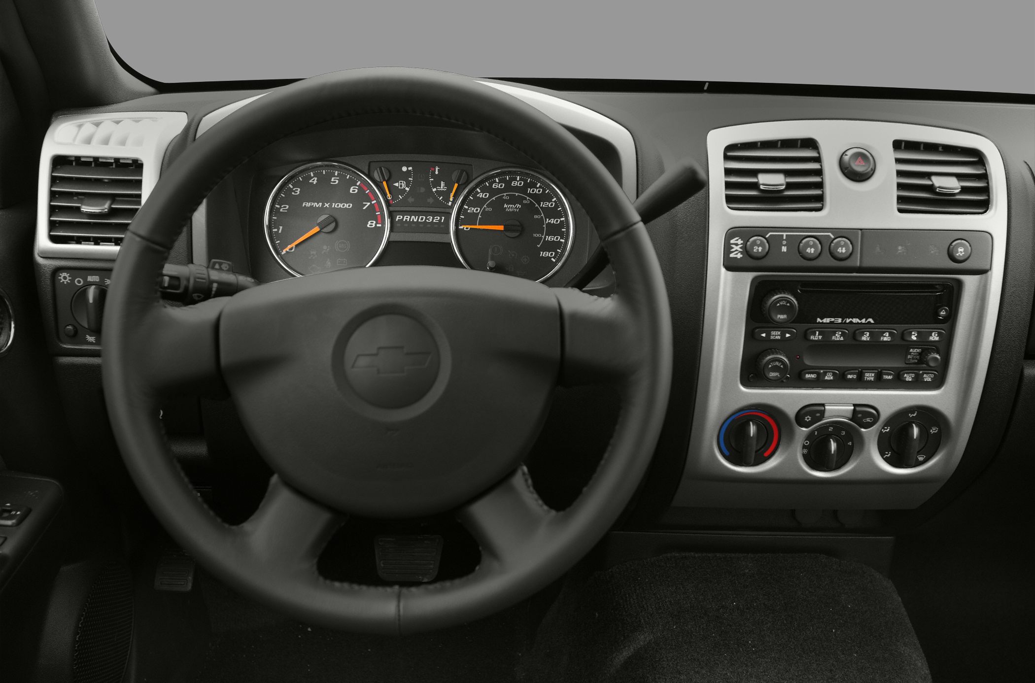 Steering wheel, instrument cluster, dashboard controls and MP3 radio.