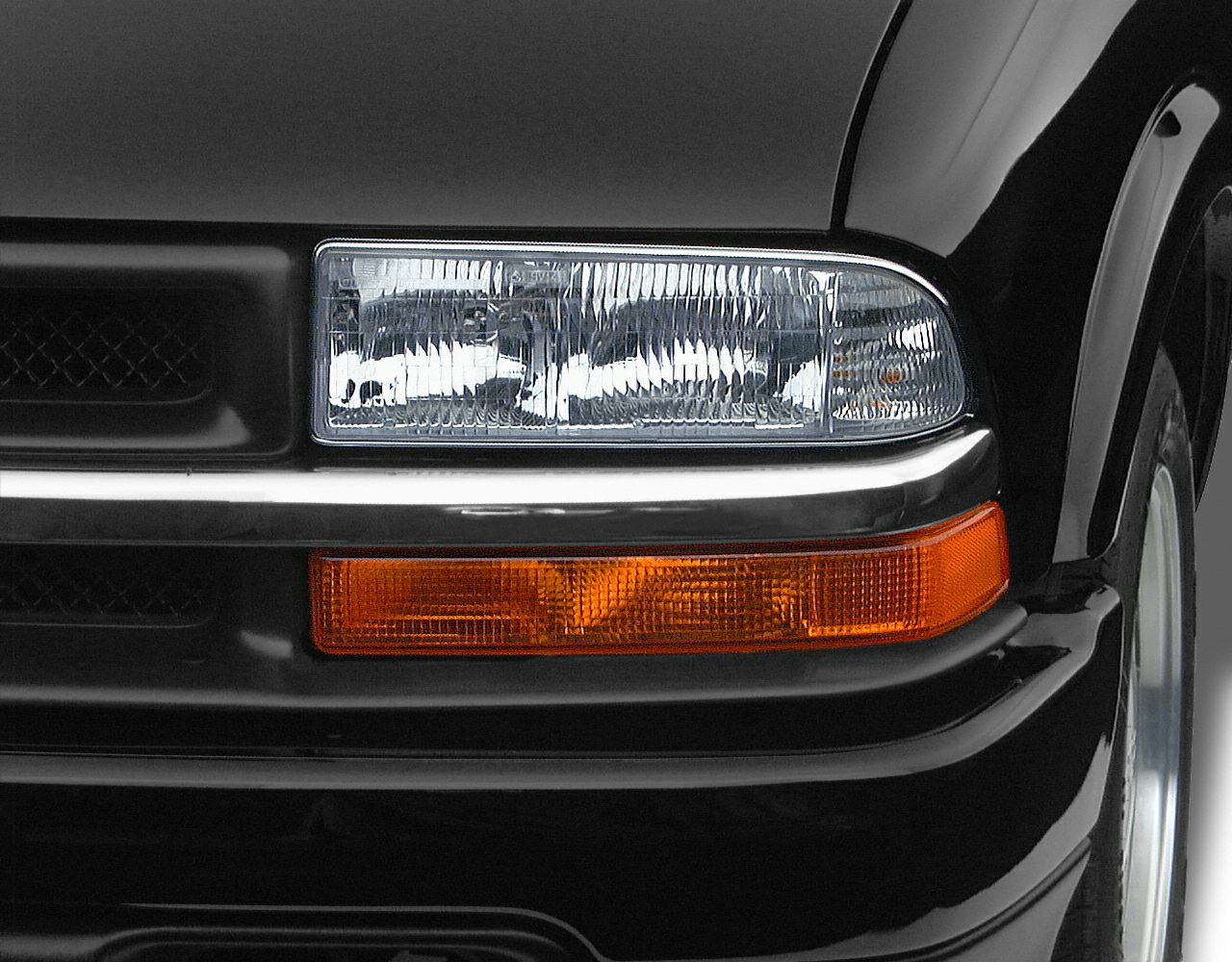 Close-up of front right headlight and amber turn signal