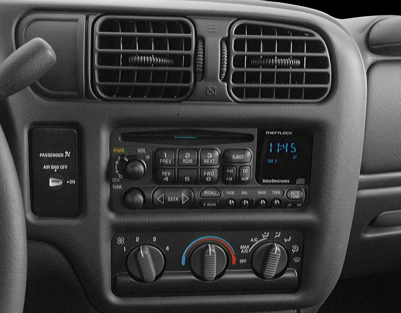 Close-up of radio, climate controls, and air vents in a truck interior.