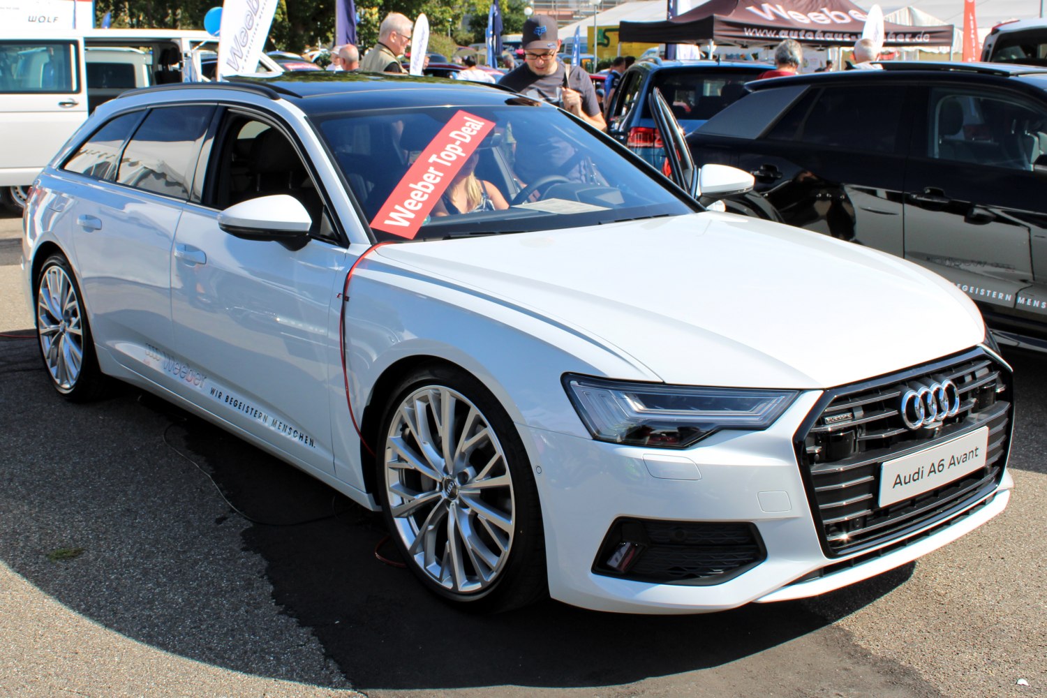 White luxury station wagon with sporty alloy wheels and LED headlights