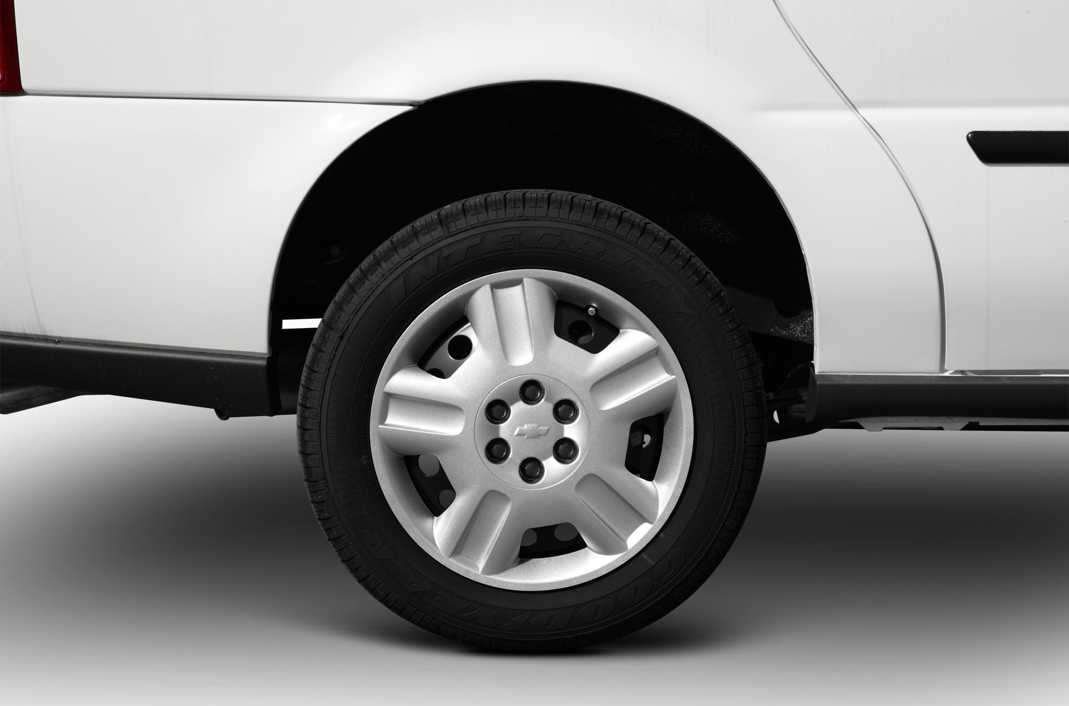 Close-up of a wheel with a distinctive hubcap on a white vehicle