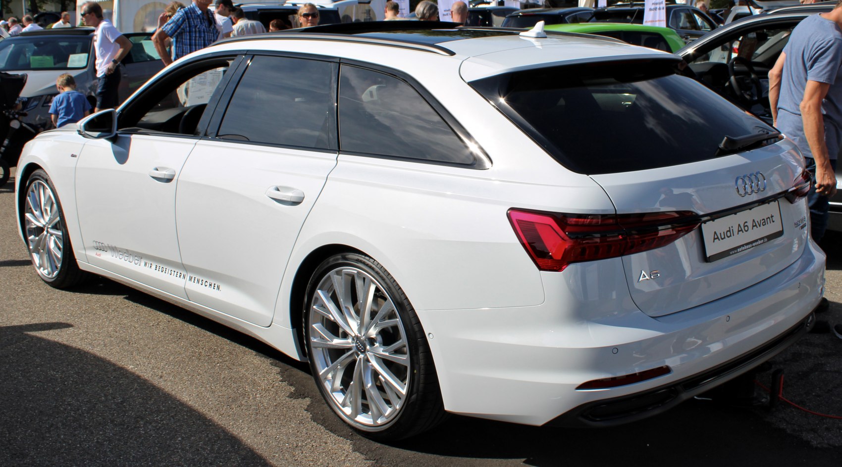 White estate car rear view with alloy wheels and modern taillights