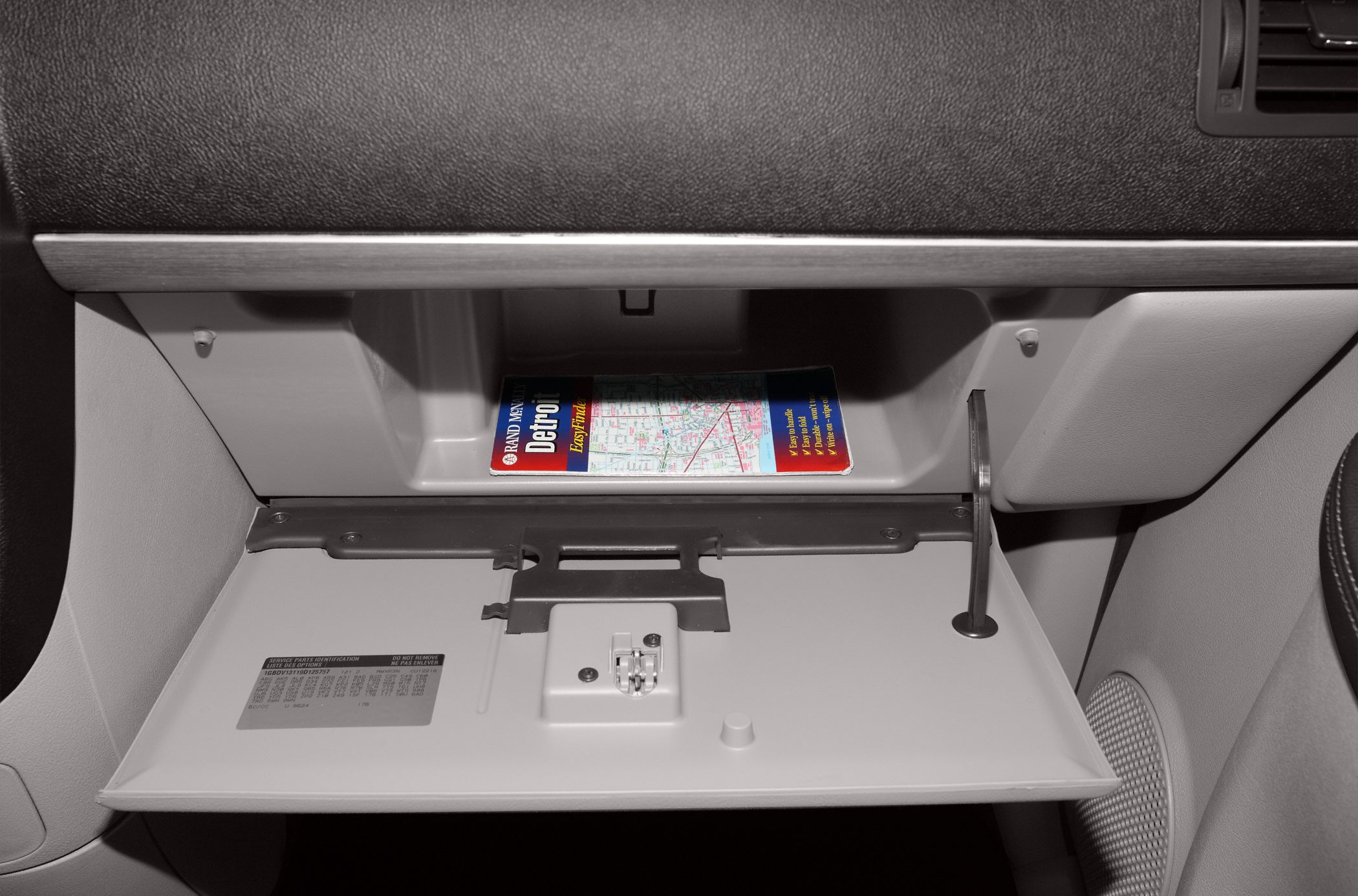 Open glove compartment with storage space and map inside