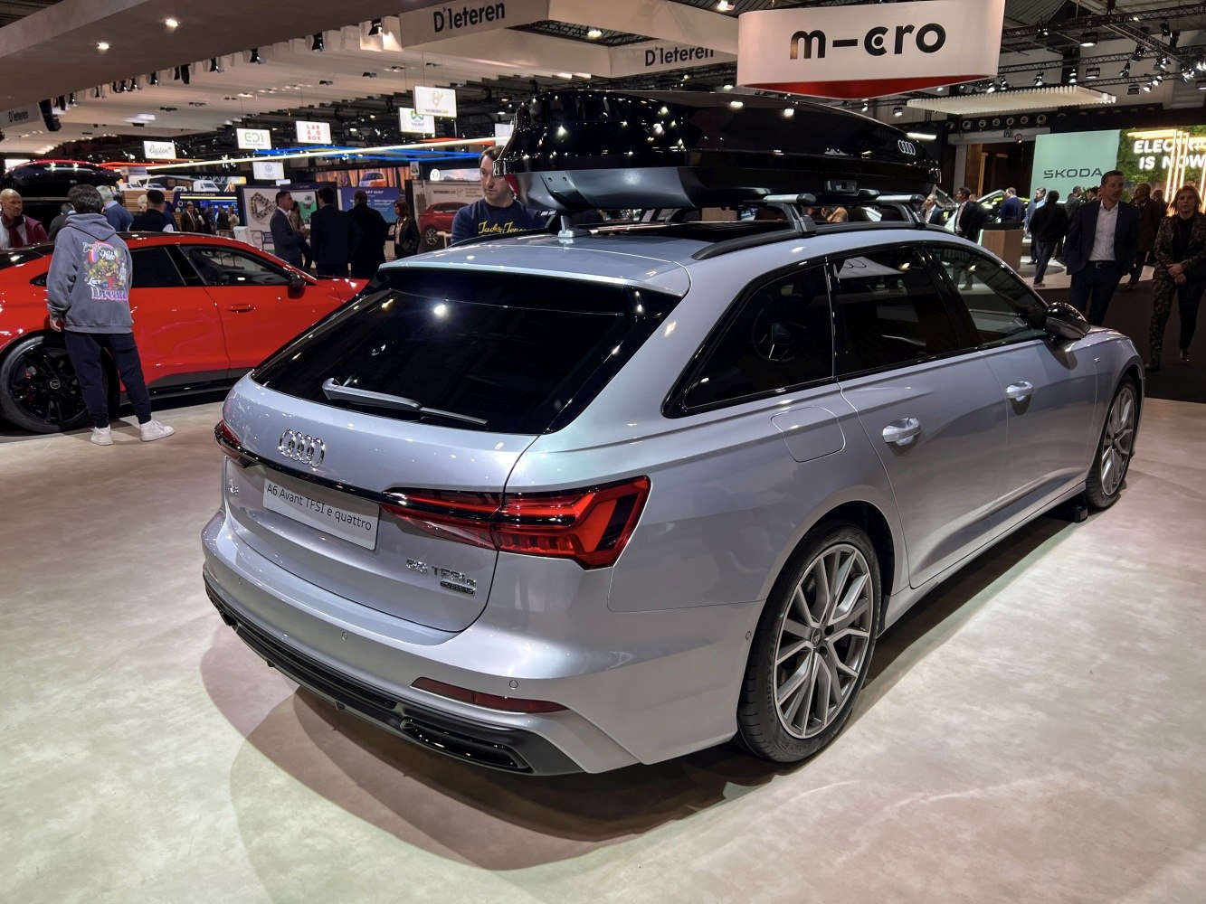 Rear view of silver station wagon with roof box and sporty wheels
