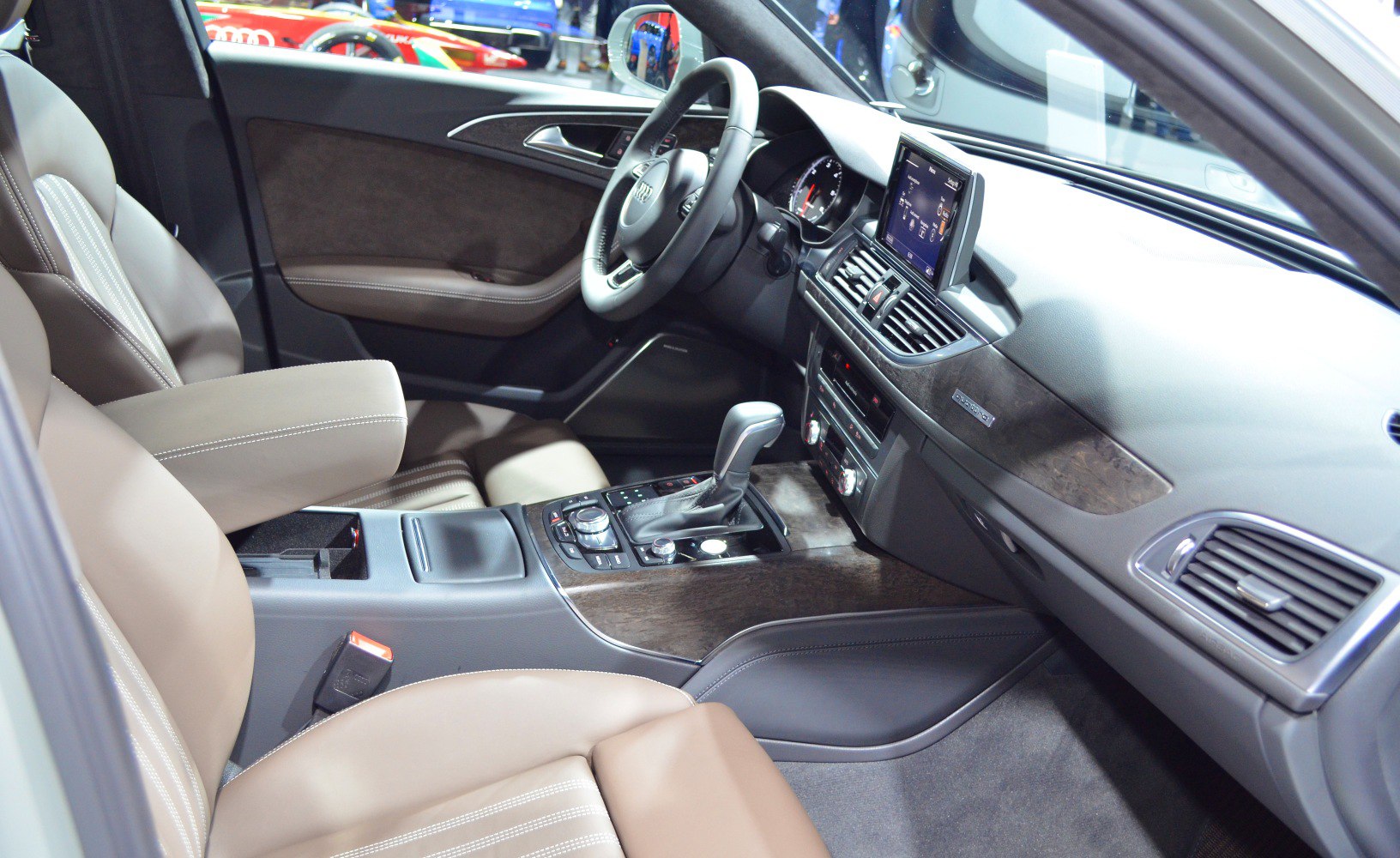 Luxury car interior with beige leather seats and advanced dashboard controls