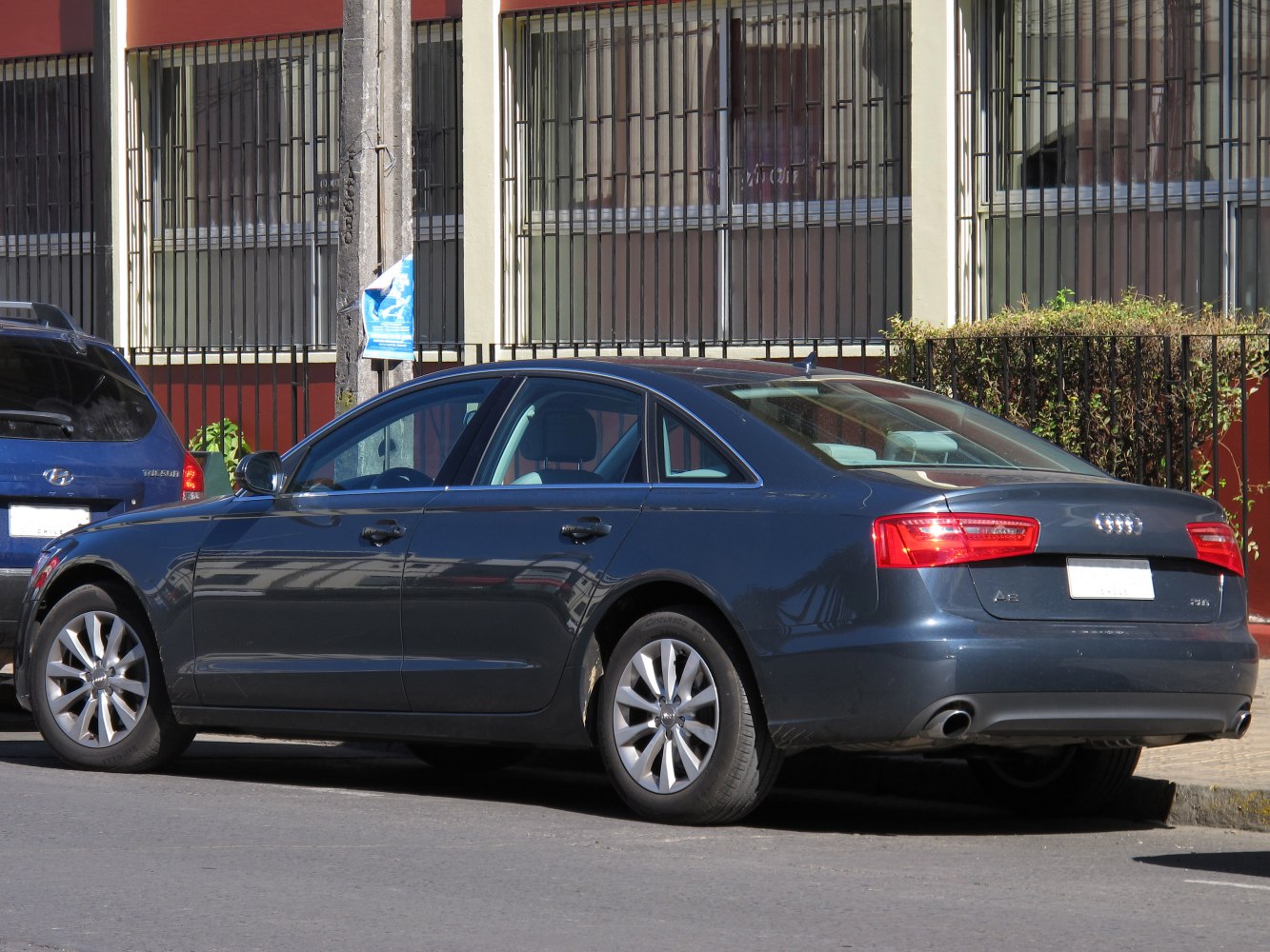 Rear-side view with sleek taillights and dual exhausts on a sedan