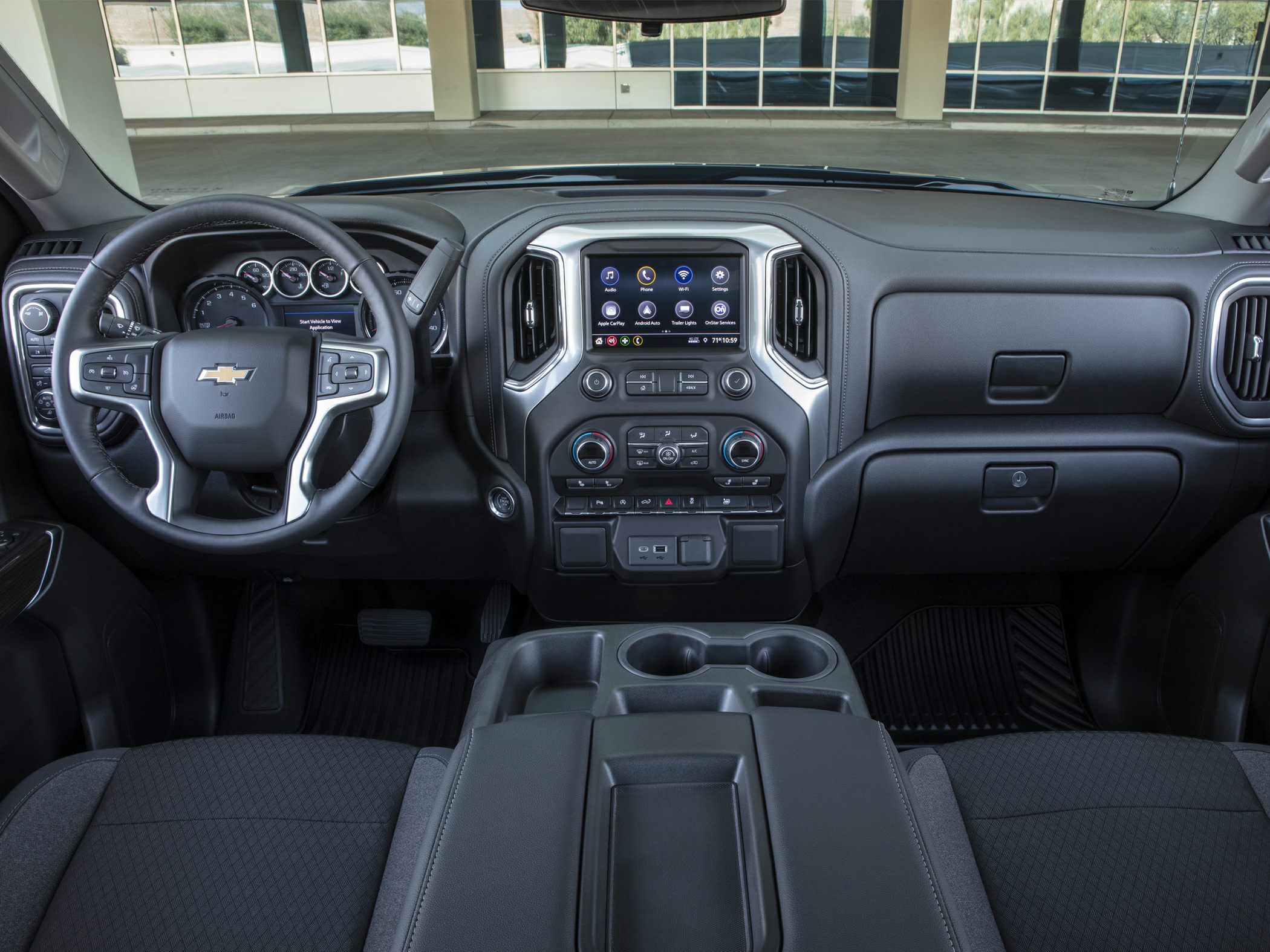 Modern truck interior with touchscreen, steering wheel controls, and spacious dashboard