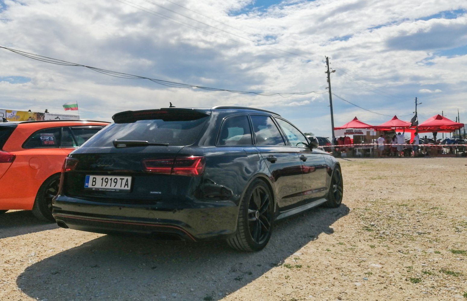 Black sports wagon with tinted taillights and black rims