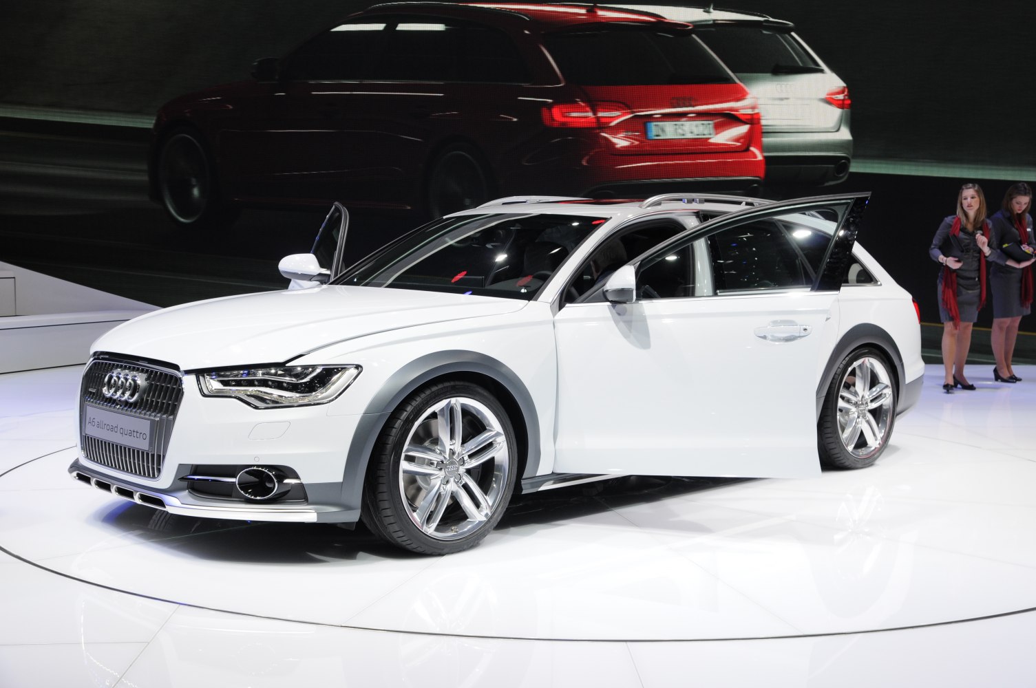 White luxury wagon with open door and bold front grille
