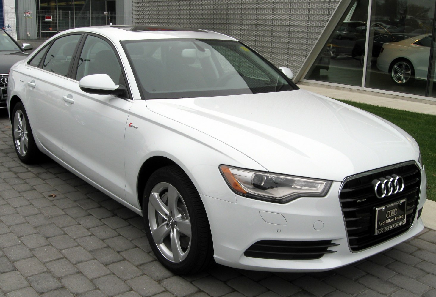 Front-side view with LED headlights and sleek sedan profile
