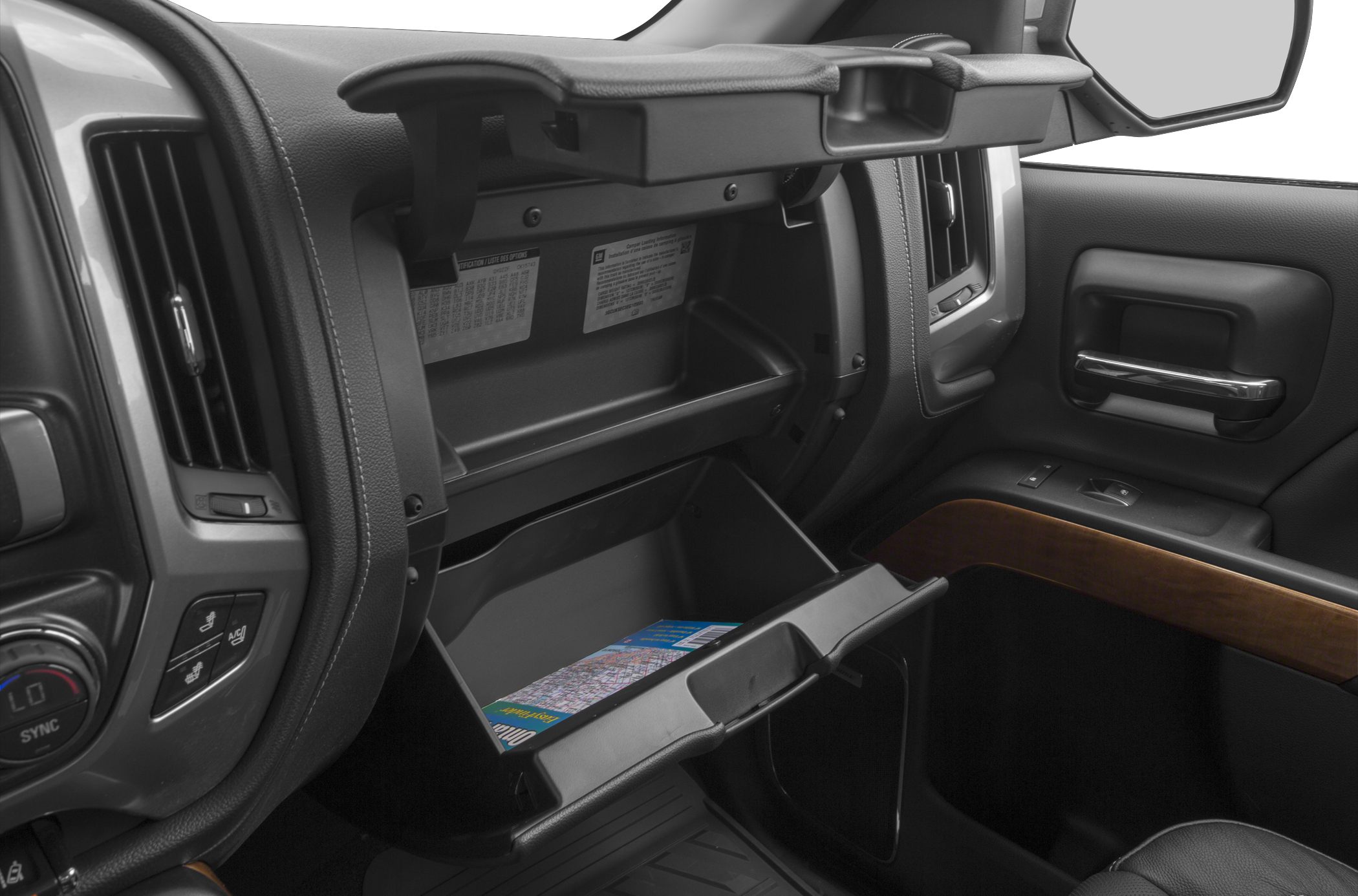 Open glove box and dashboard with control panel and wood trim