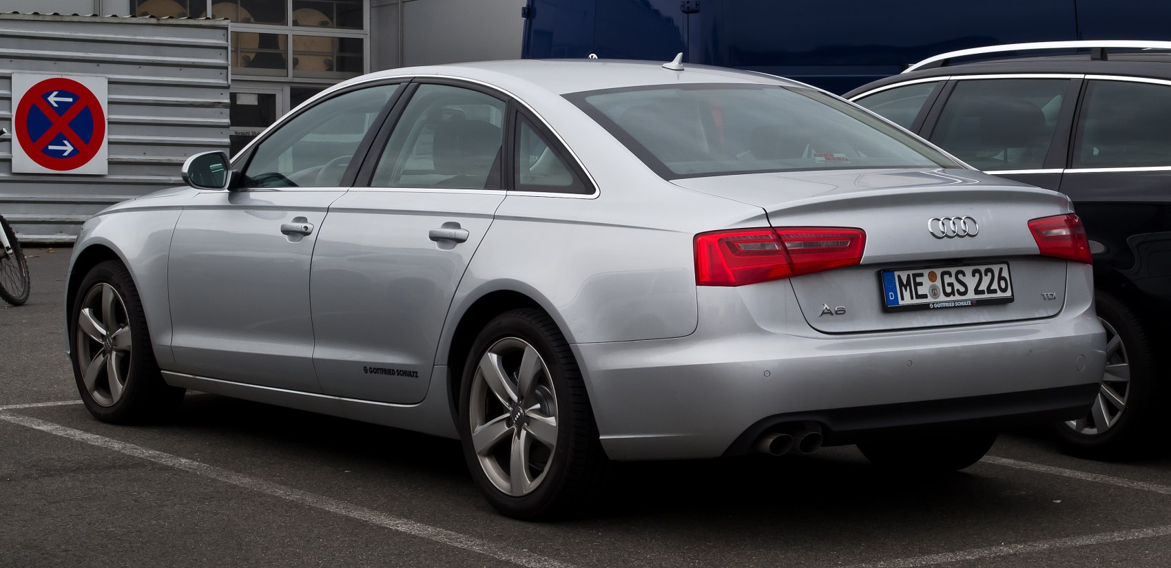 Silver luxury sedan rear side with sleek design and LED taillights