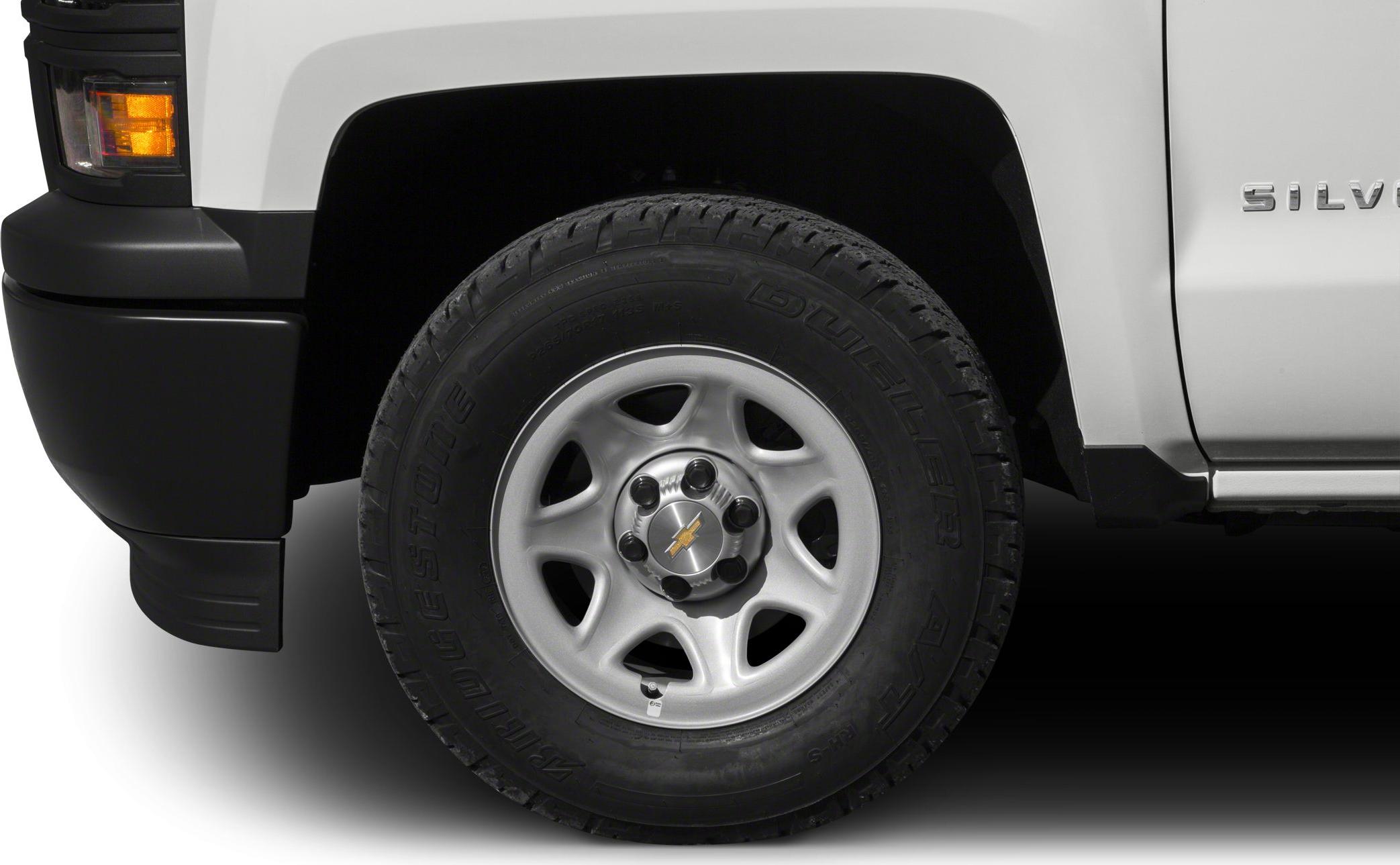 Steel wheel with Bridgestone Dueler A/T tire on white pickup
