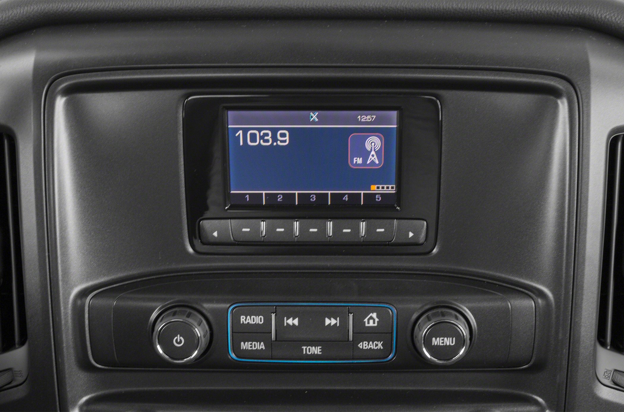 Close-up of car radio panel with FM display and preset buttons
