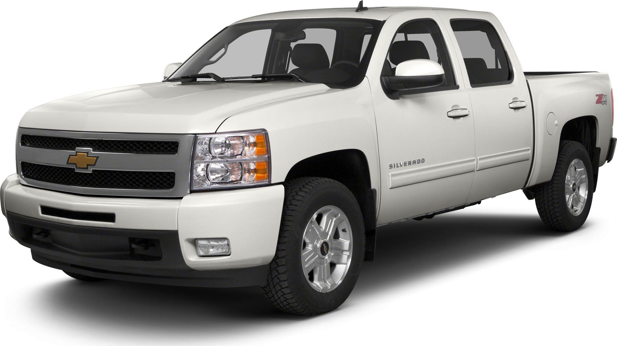 Front-side view of white crew cab pickup with dual headlamps and standard box