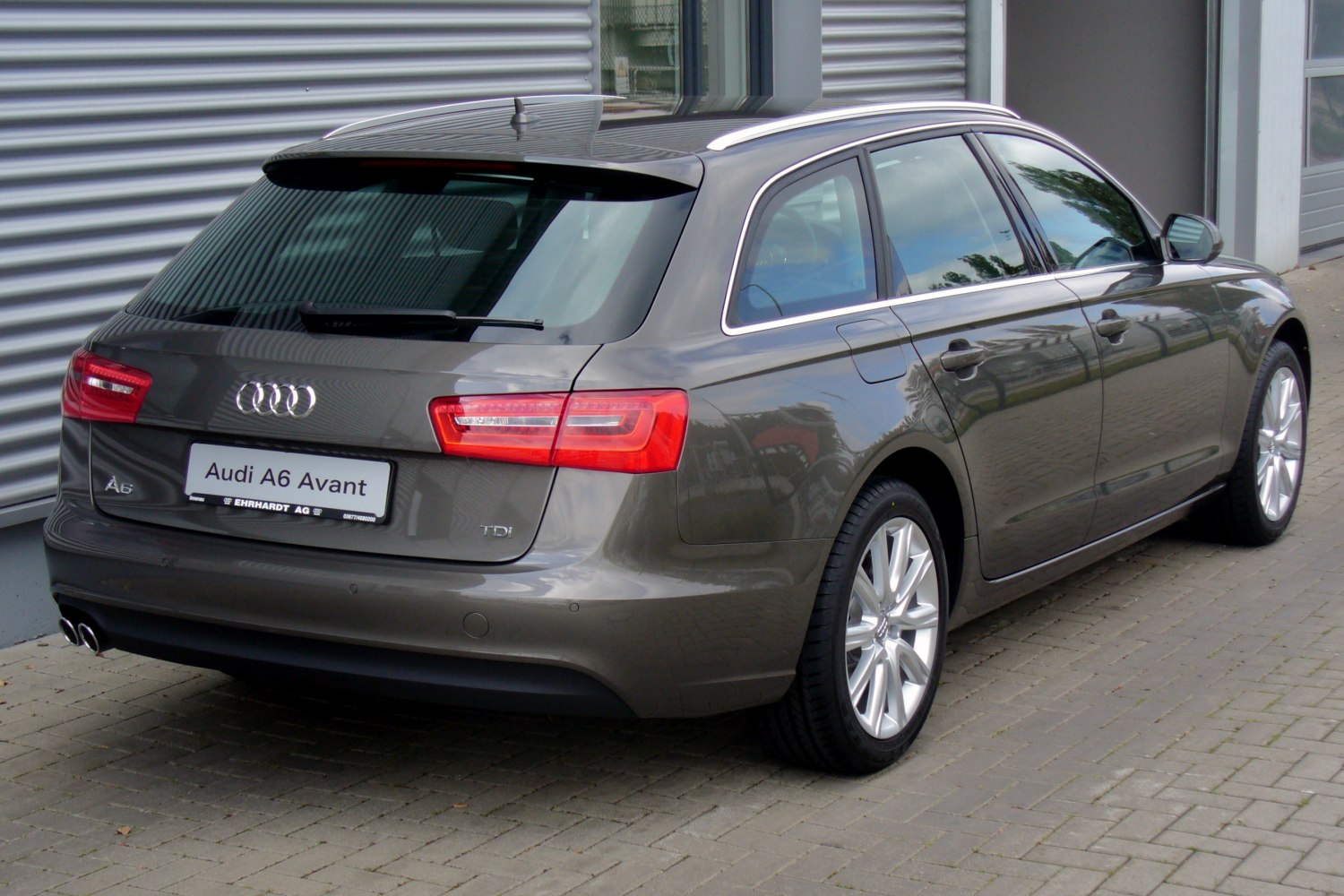 Rear three-quarter view of a station wagon with distinctive taillights and dual exhaust