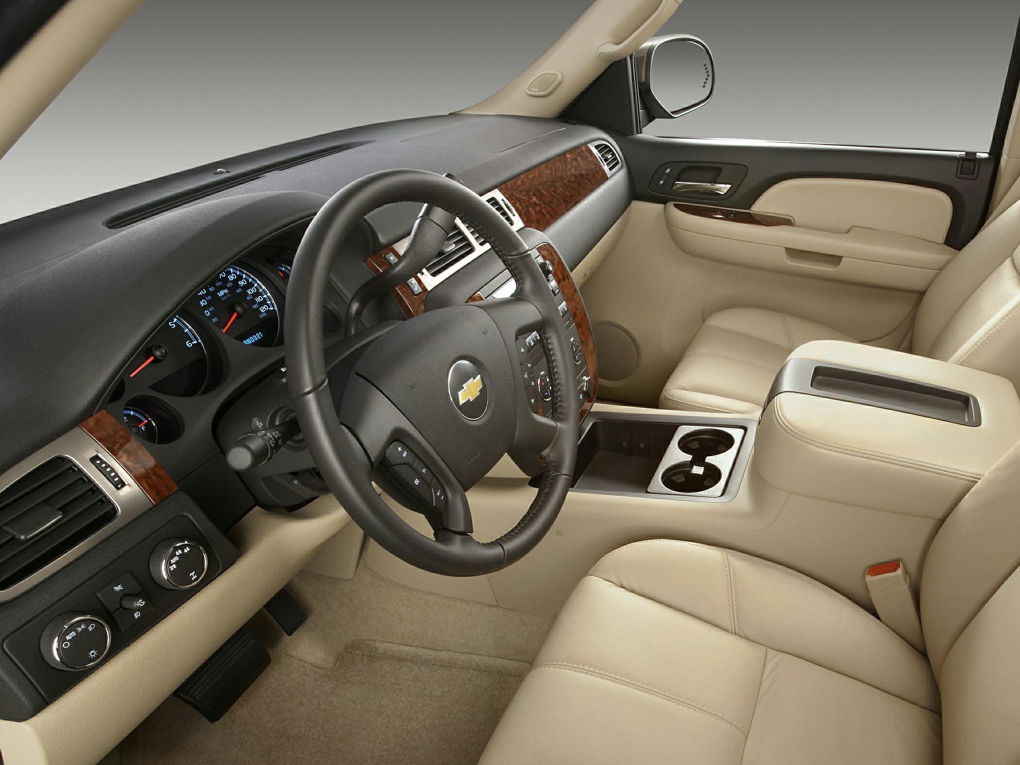 Beige leather interior with wood trim and steering wheel controls