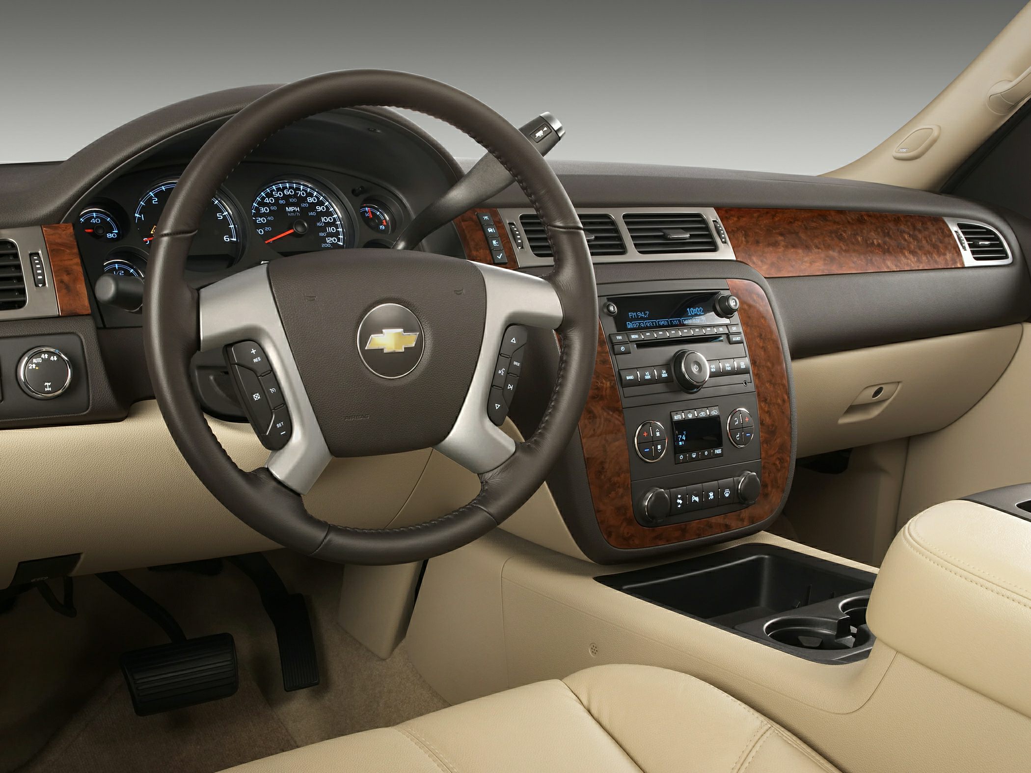 Dashboard and steering wheel with wood trim and instrument cluster