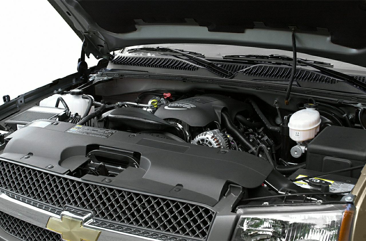 Close-up of a truck's engine bay with visible Vortec engine and components