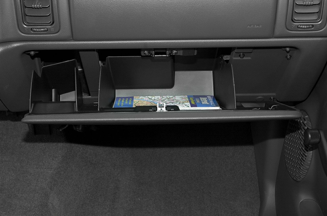 Open glove compartment with organized interior storage and a map visible inside