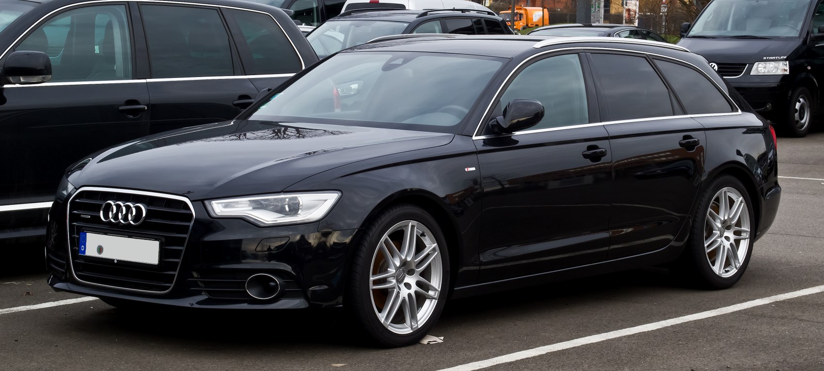 Front side view of black station wagon with alloy wheels and sleek bodywork