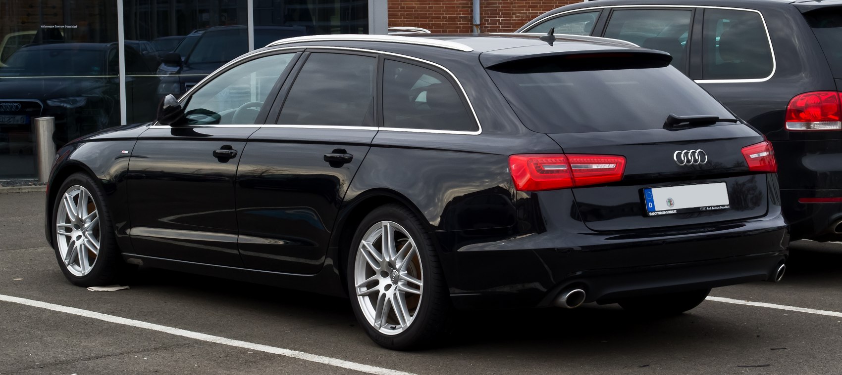 Rear side view of a sporty station wagon with alloy wheels and dual exhausts