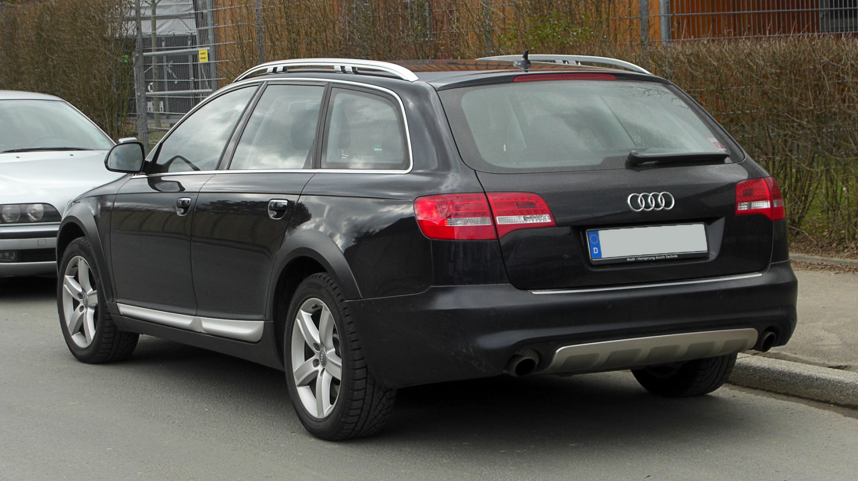 Rear and side view of estate car with roof rails and rugged design