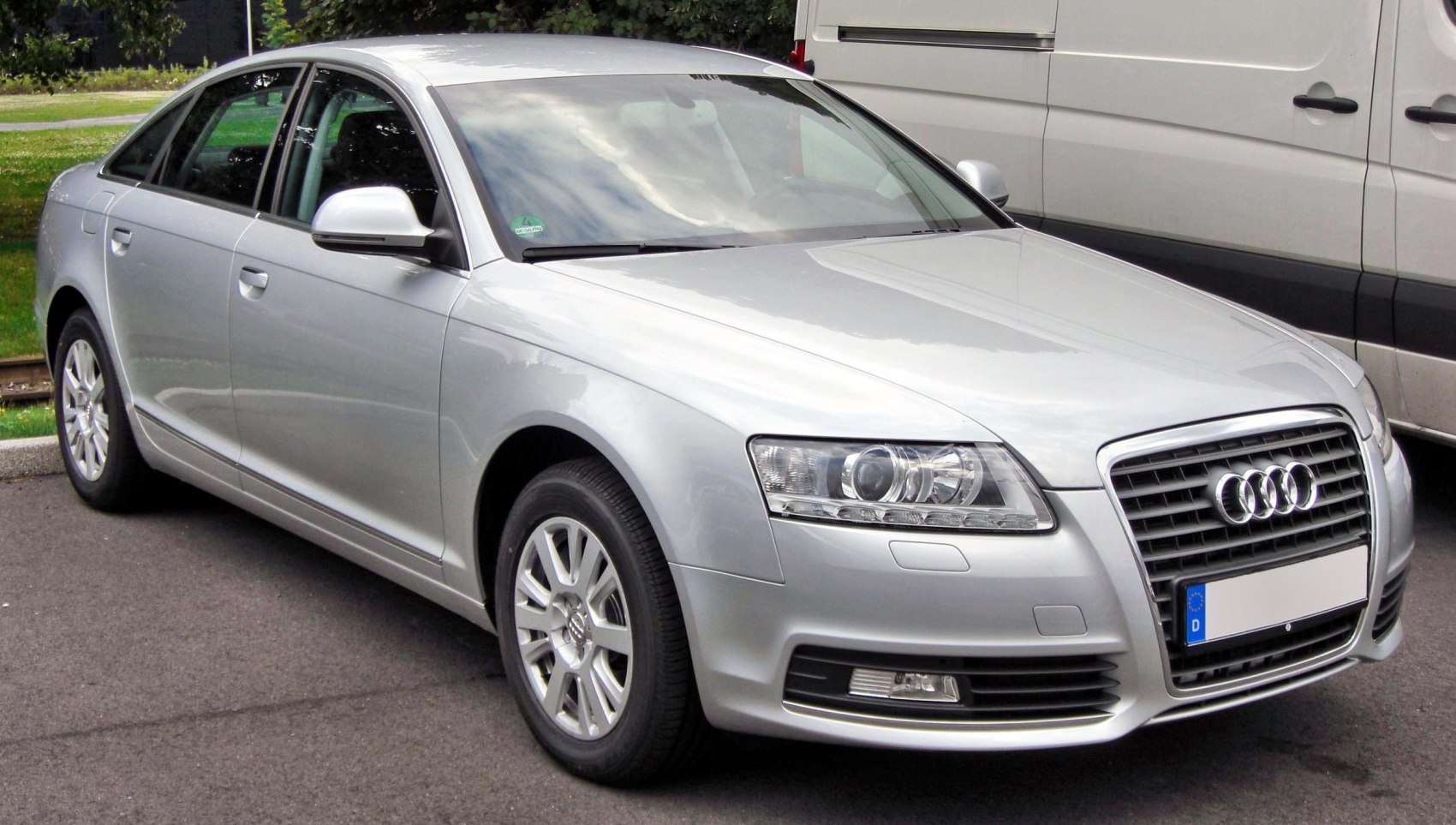 Silver sedan with distinctive grille and projector headlights