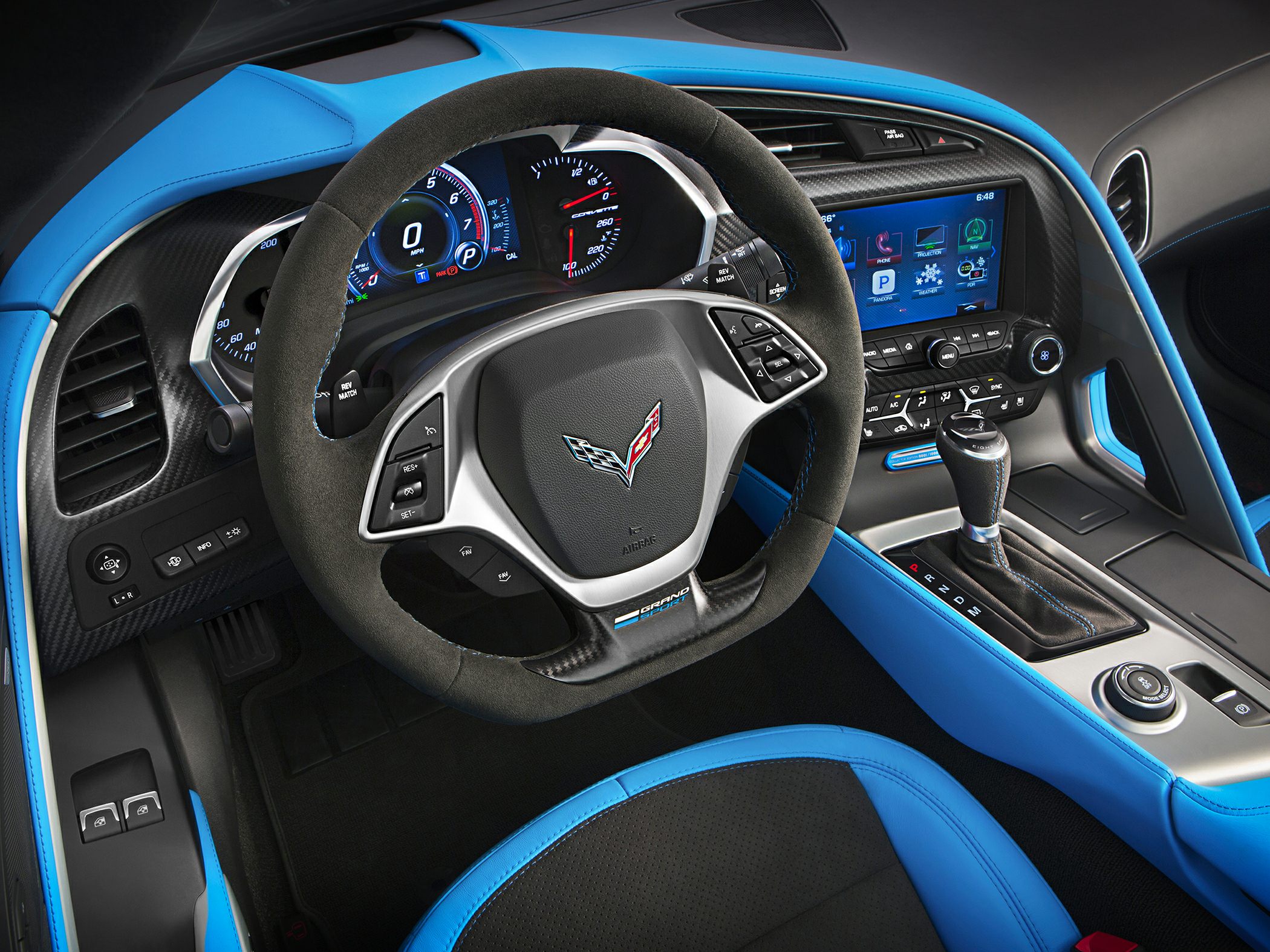 Digital dashboard, sporty steering wheel, infotainment display, center console with gear selector