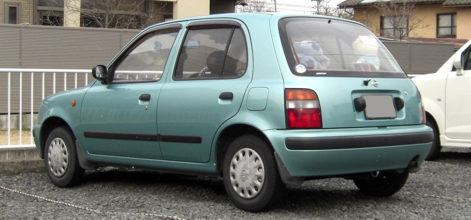 Rear side view of a compact hatchback with distinctive rounded design and small steel wheels