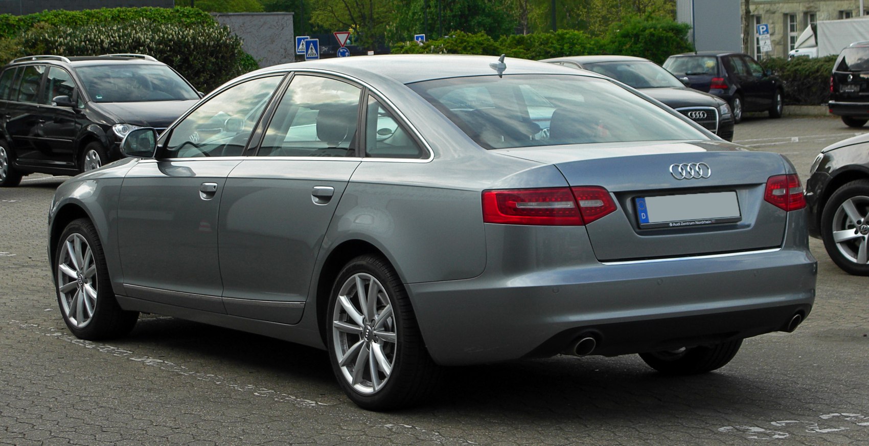 Rear view of a sedan with LED tail lights and dual exhaust pipes.