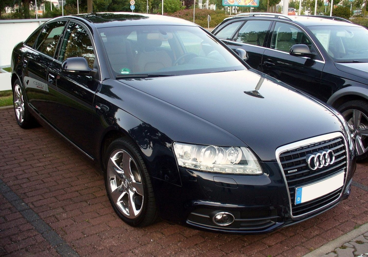 Front grille, headlights, and alloy wheels of a luxury sedan