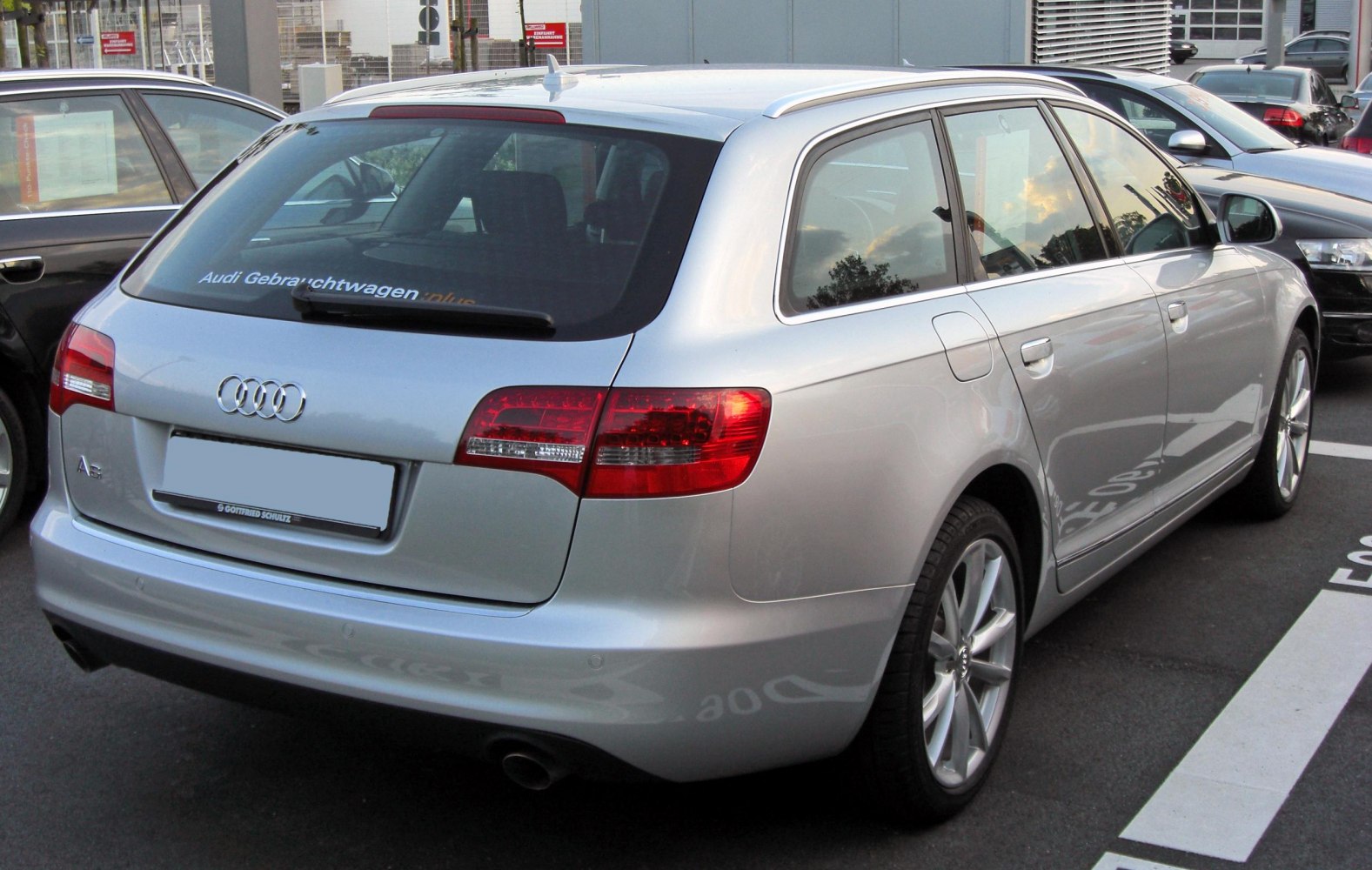 Silver station wagon rear side with LED taillights and alloy wheels