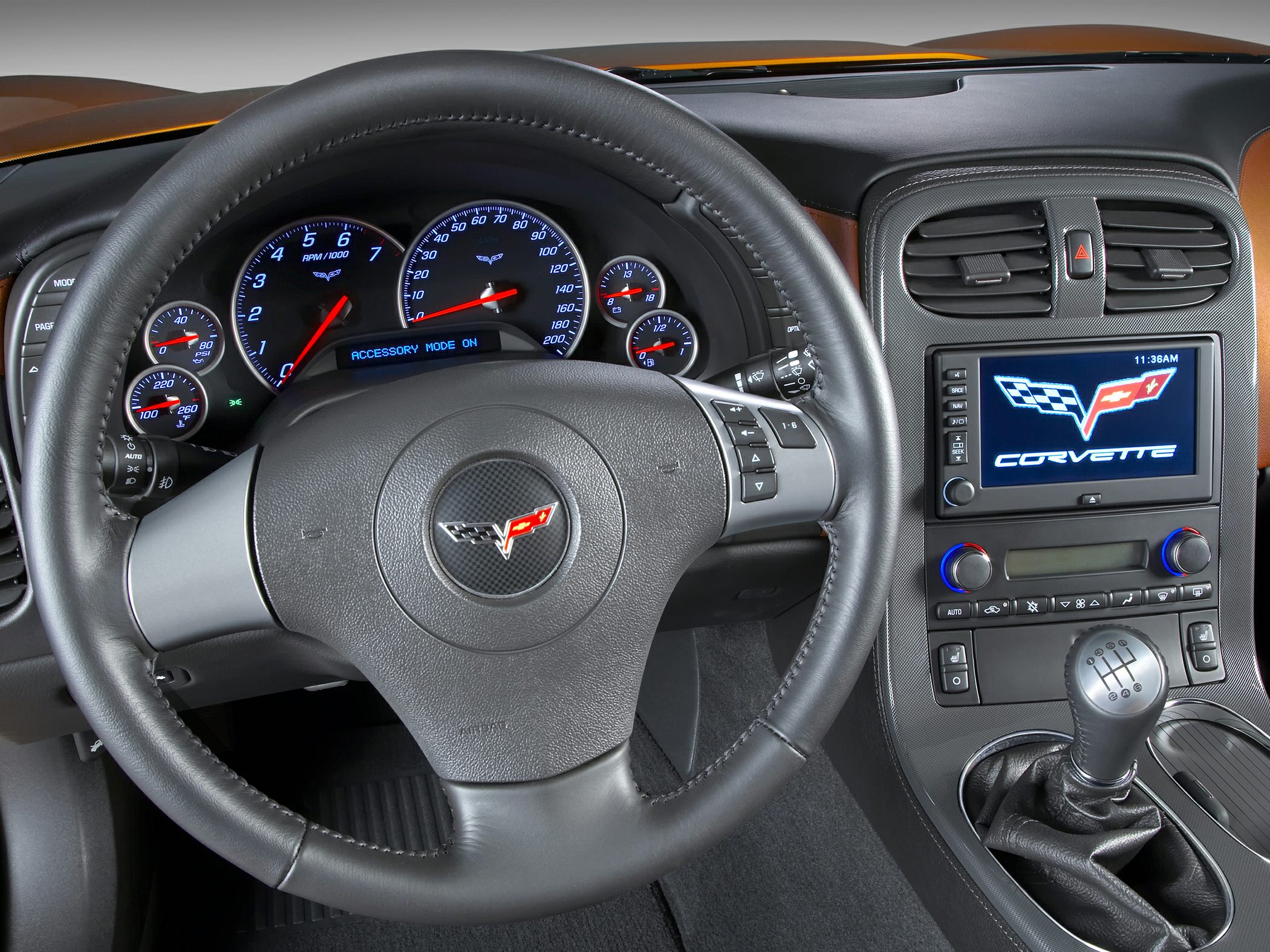 Steering wheel, dashboard gauges, touchscreen, manual gear shift knob