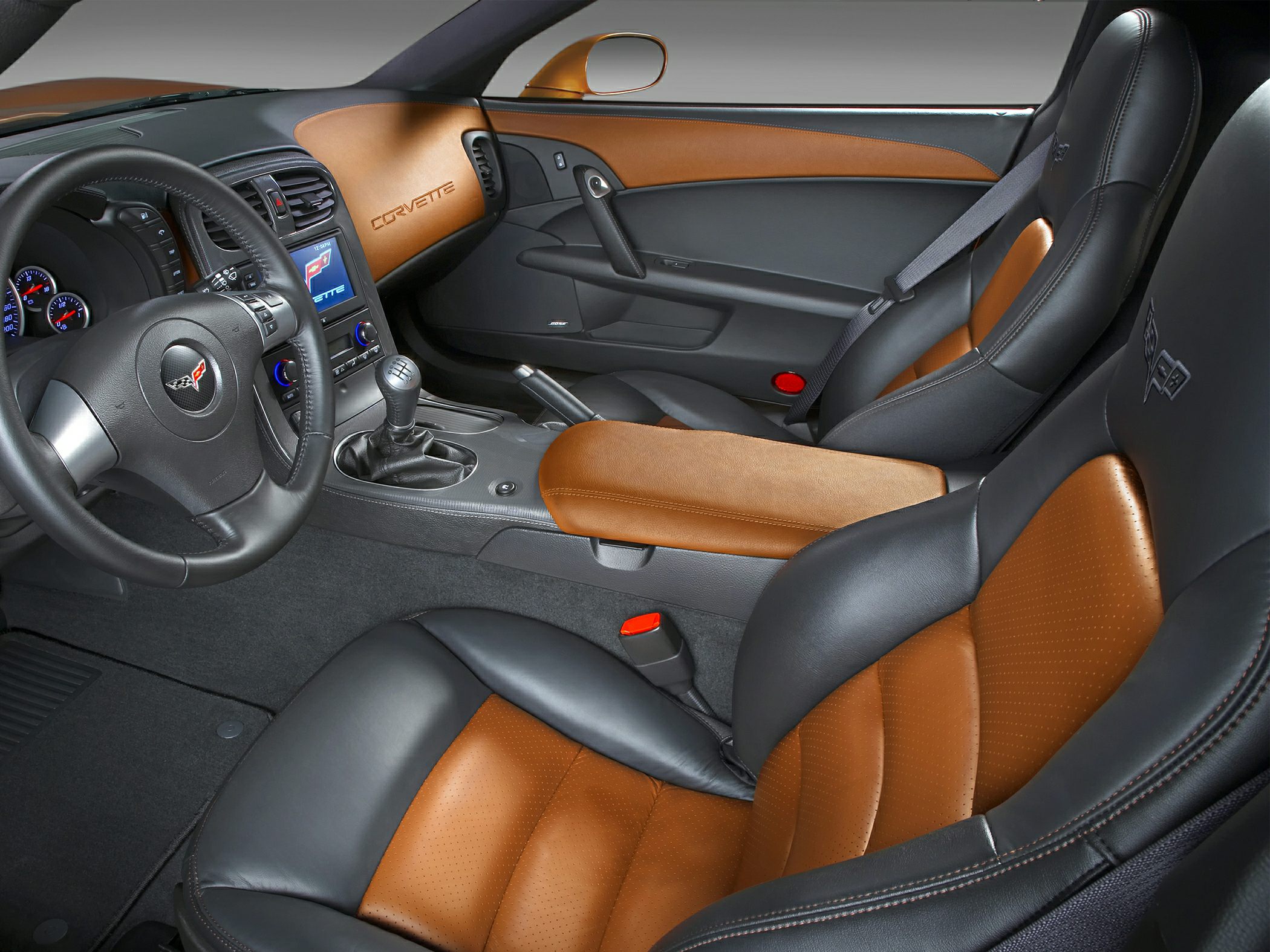 Two-tone brown and black leather seats with dashboard and manual gear shifter