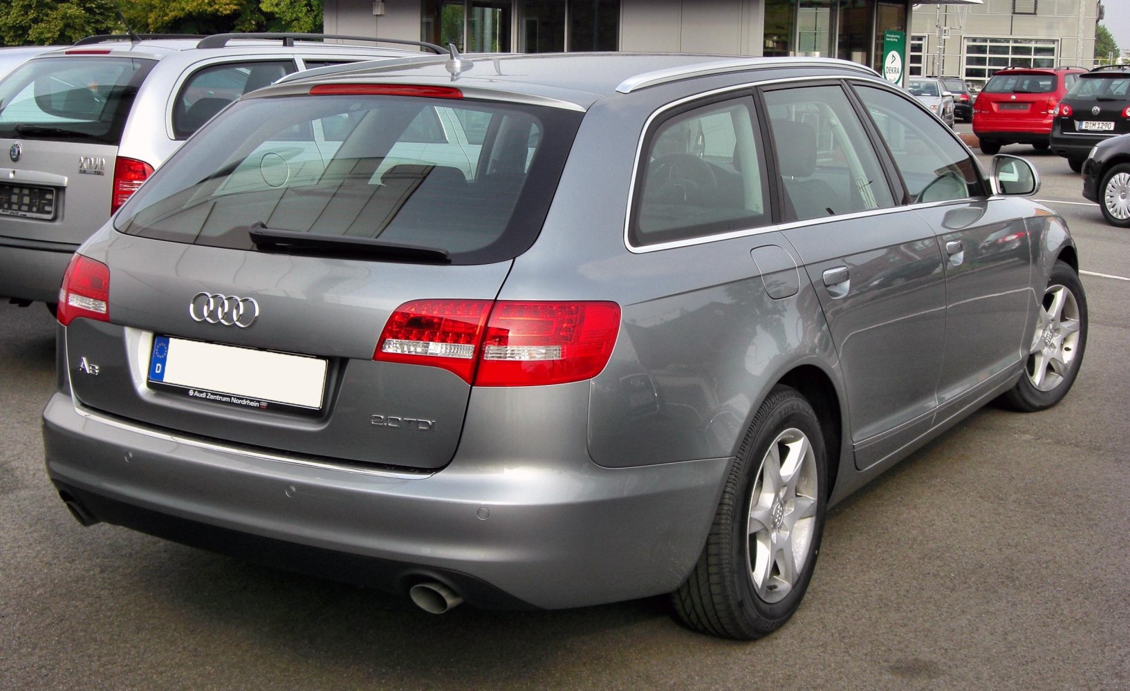 Rear-side view of silver estate with LED taillights and roof rails