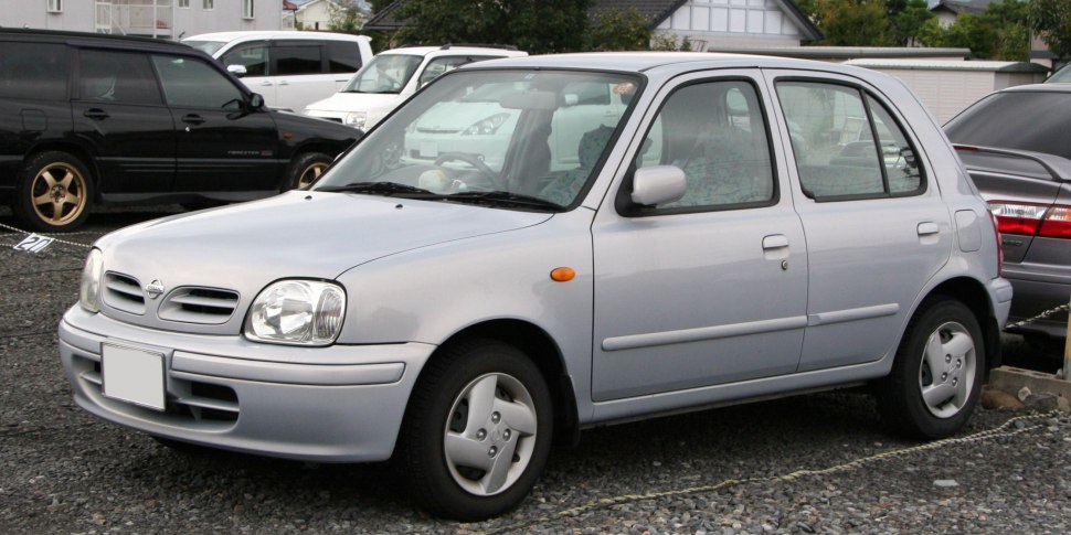 Silver compact hatchback with rounded headlights and simple body design