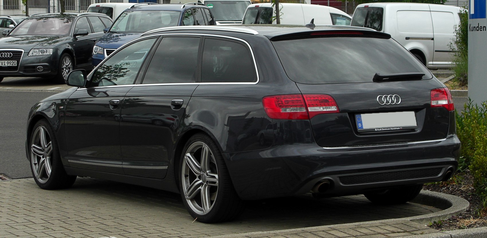 Rear-side view of a sleek station wagon with distinctive taillights and alloy wheels