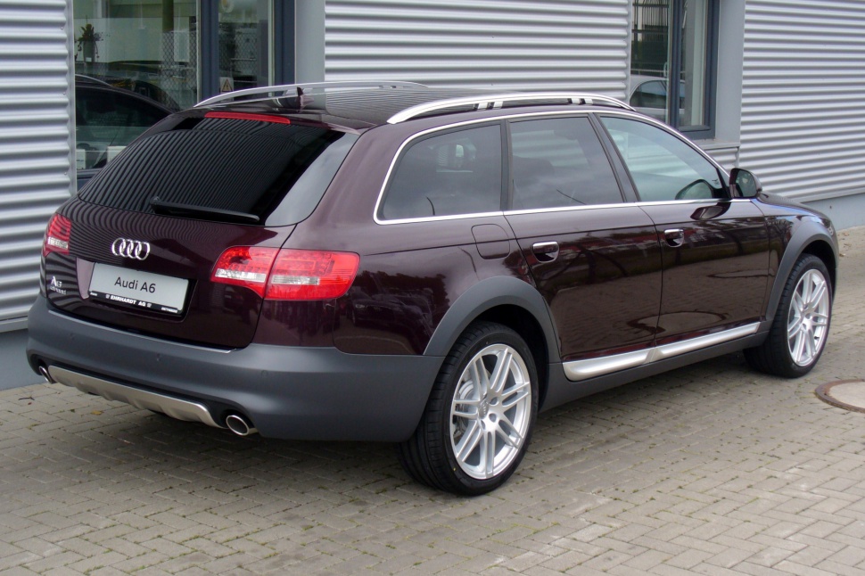 Rear-side view with roof rails, body cladding, and alloy wheels