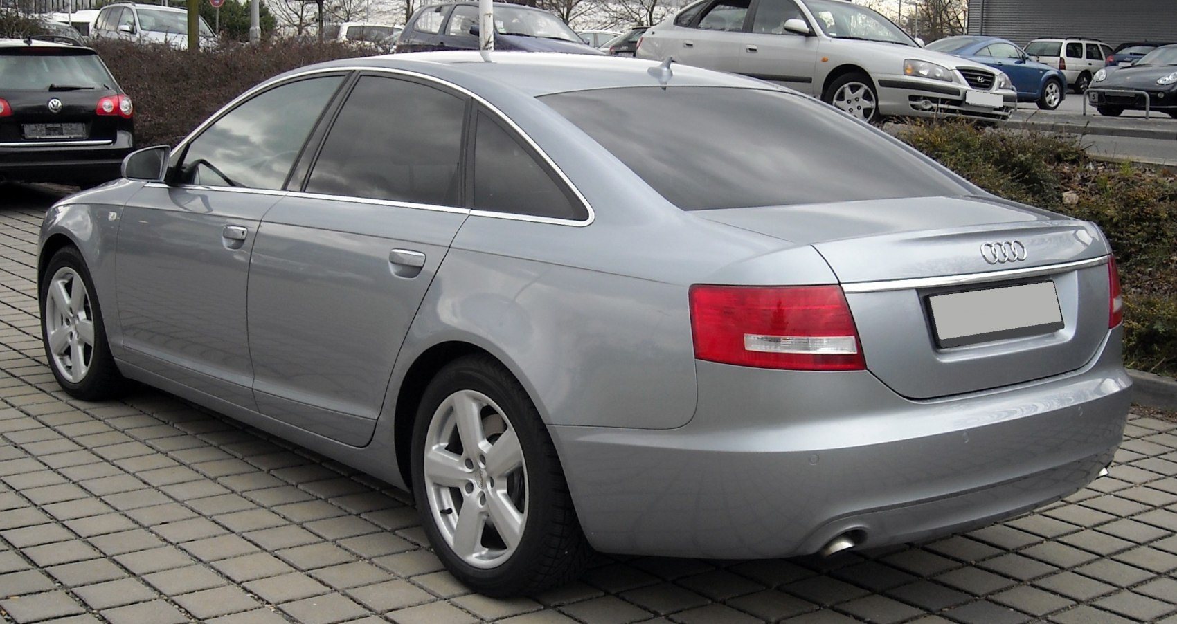 Rear view of silver sedan with angular tail lights and alloy wheels