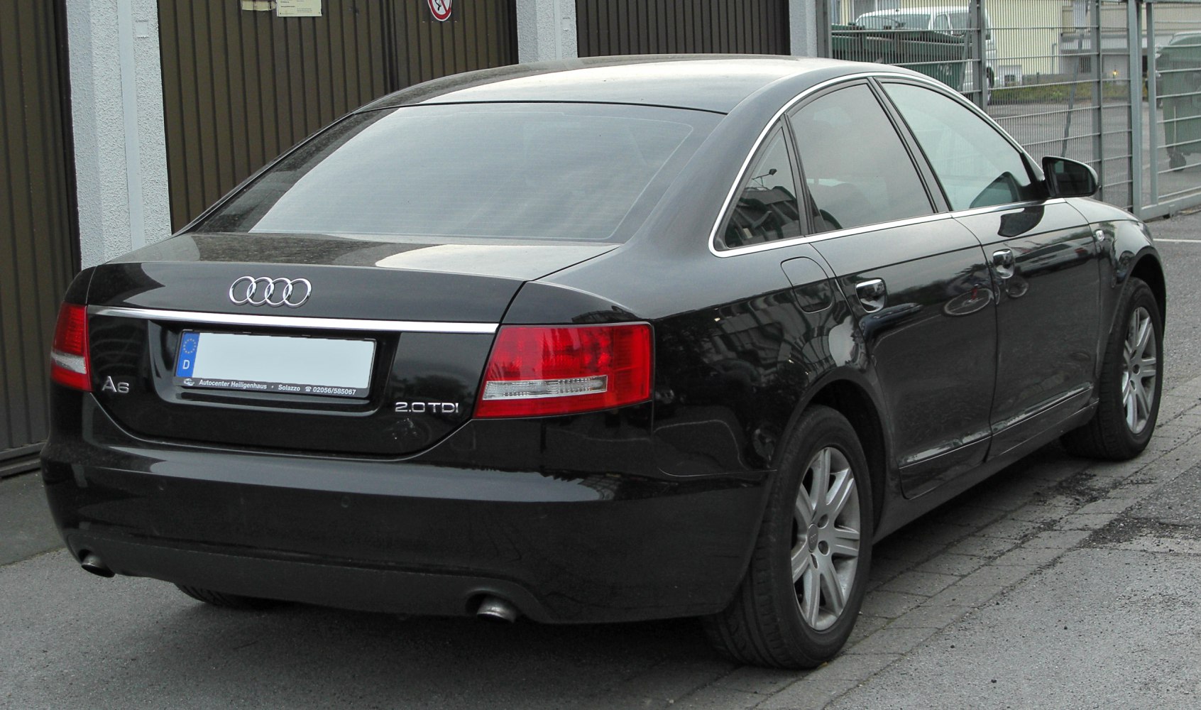 Rear view of black sedan with 2.0 TDI badge and distinctive taillights.
