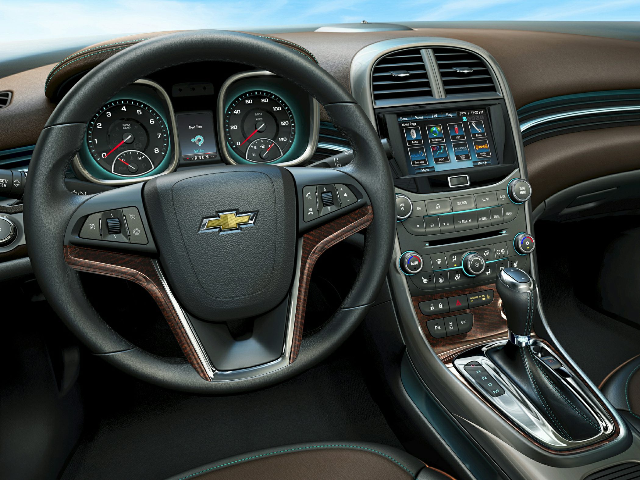 Steering wheel, dashboard gauges, and touchscreen infotainment system.