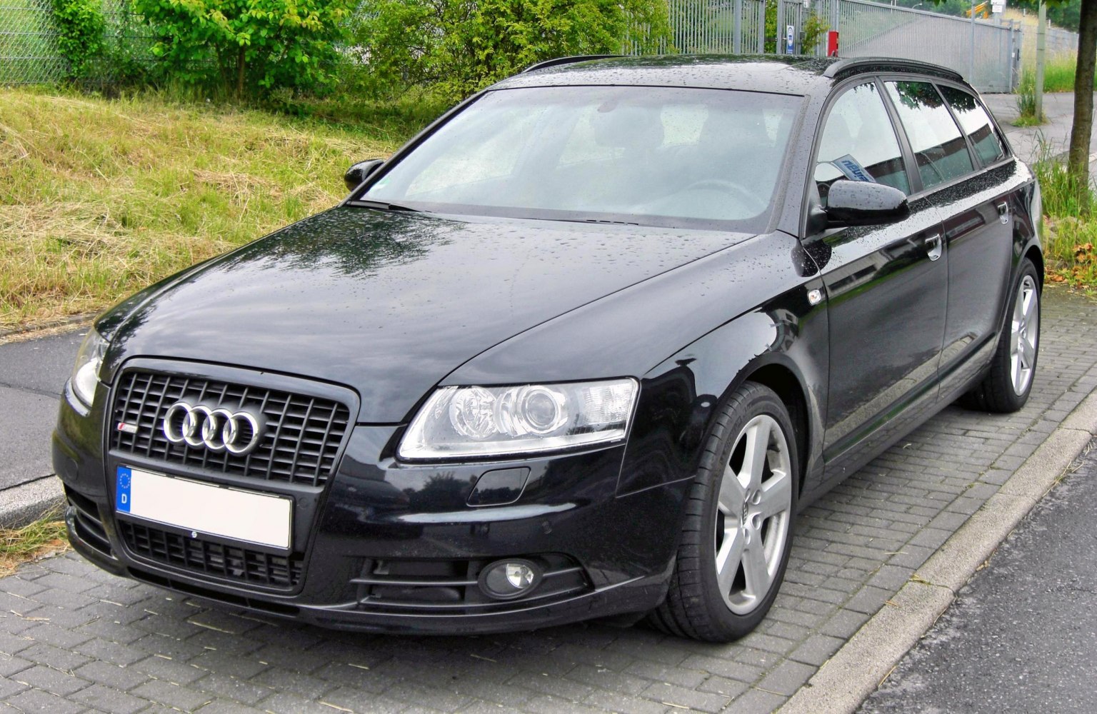 Black station wagon front with alloy wheels and roof rails